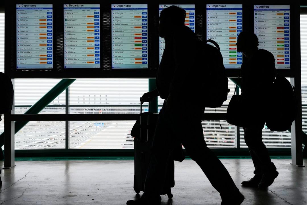 Travelers walk though the terminal at O'Hare International Airport, in Chicago, Sunday, Nov. 30, 2025. (AP Photo/Nam Y. Huh)
