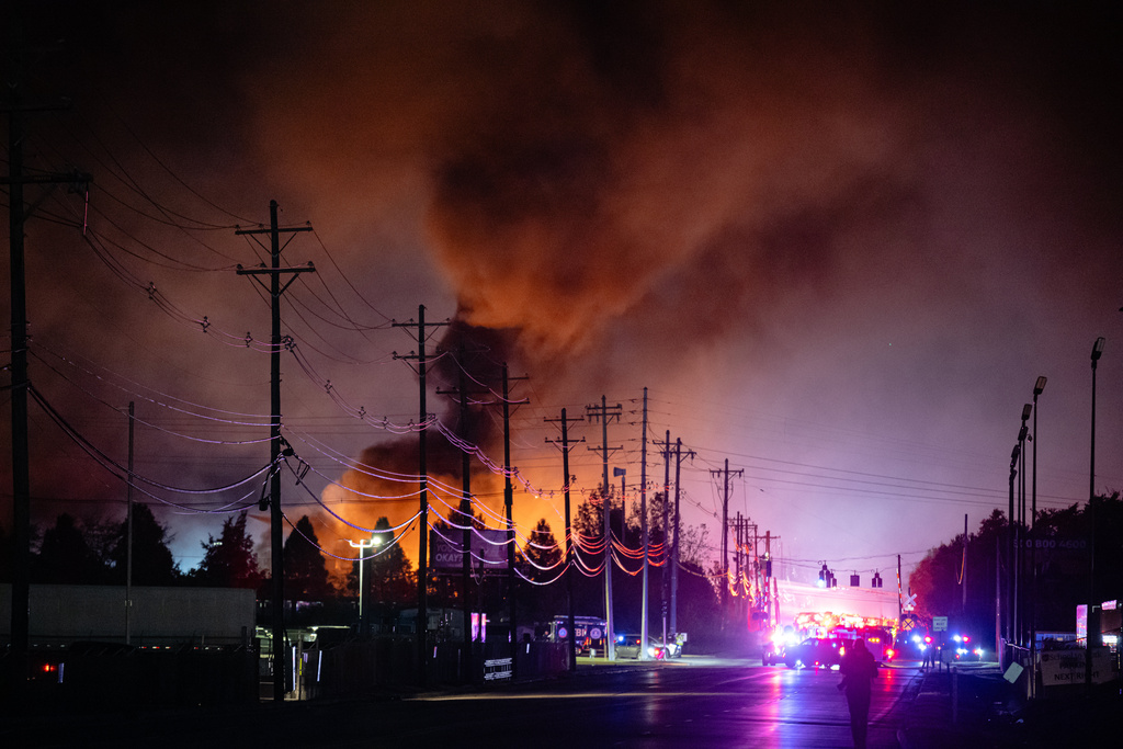 Plumes of smoke rise from the area of a UPS cargo plane crash at Louisville Muhammad Ali International Airport, on Tuesday, Nov. 4, 2025