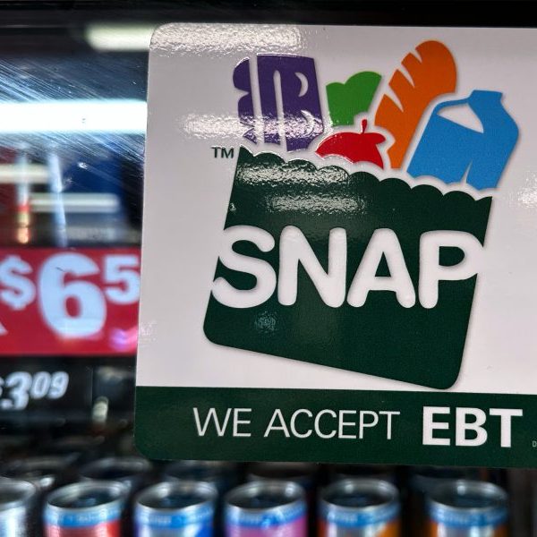 sign at gas station checkout reading SNAP: WE ACCEPT EBT