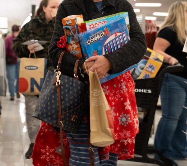 A person holding various shopping bags