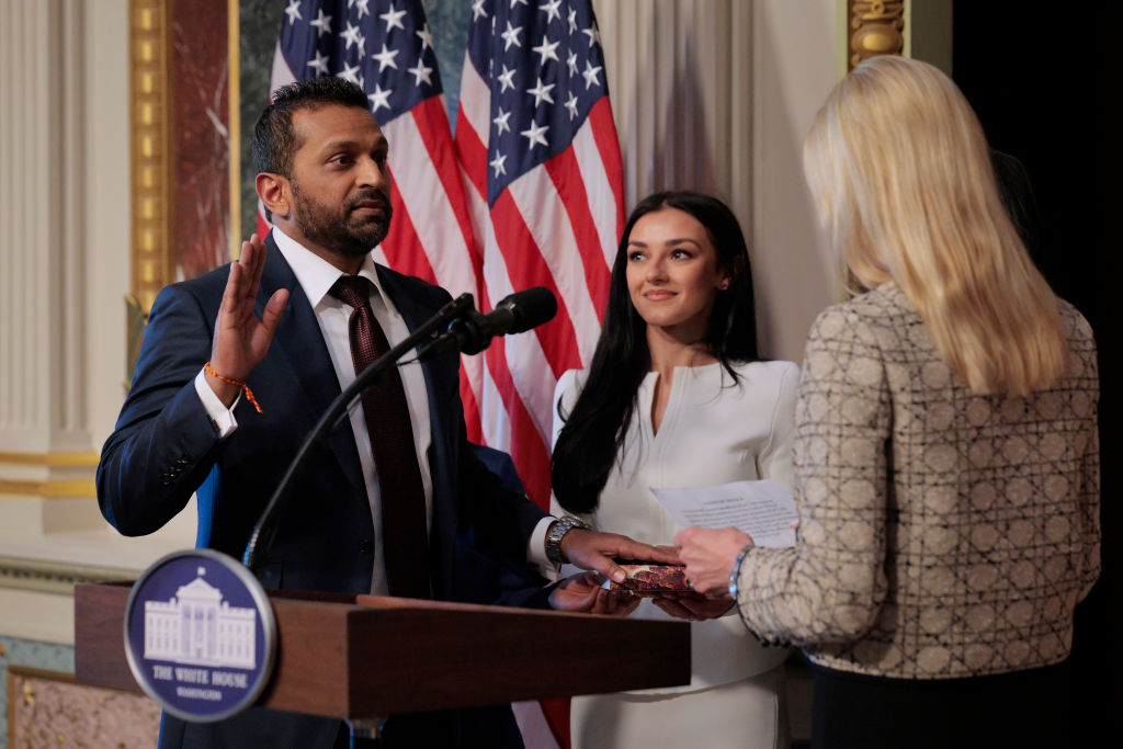 U.S. Attorney General Pam Bondi swears in the new Federal Bureau of Investigation Director Kash Patel as his girlfriend Alexis Wilkins holds the Bhagavad Gita