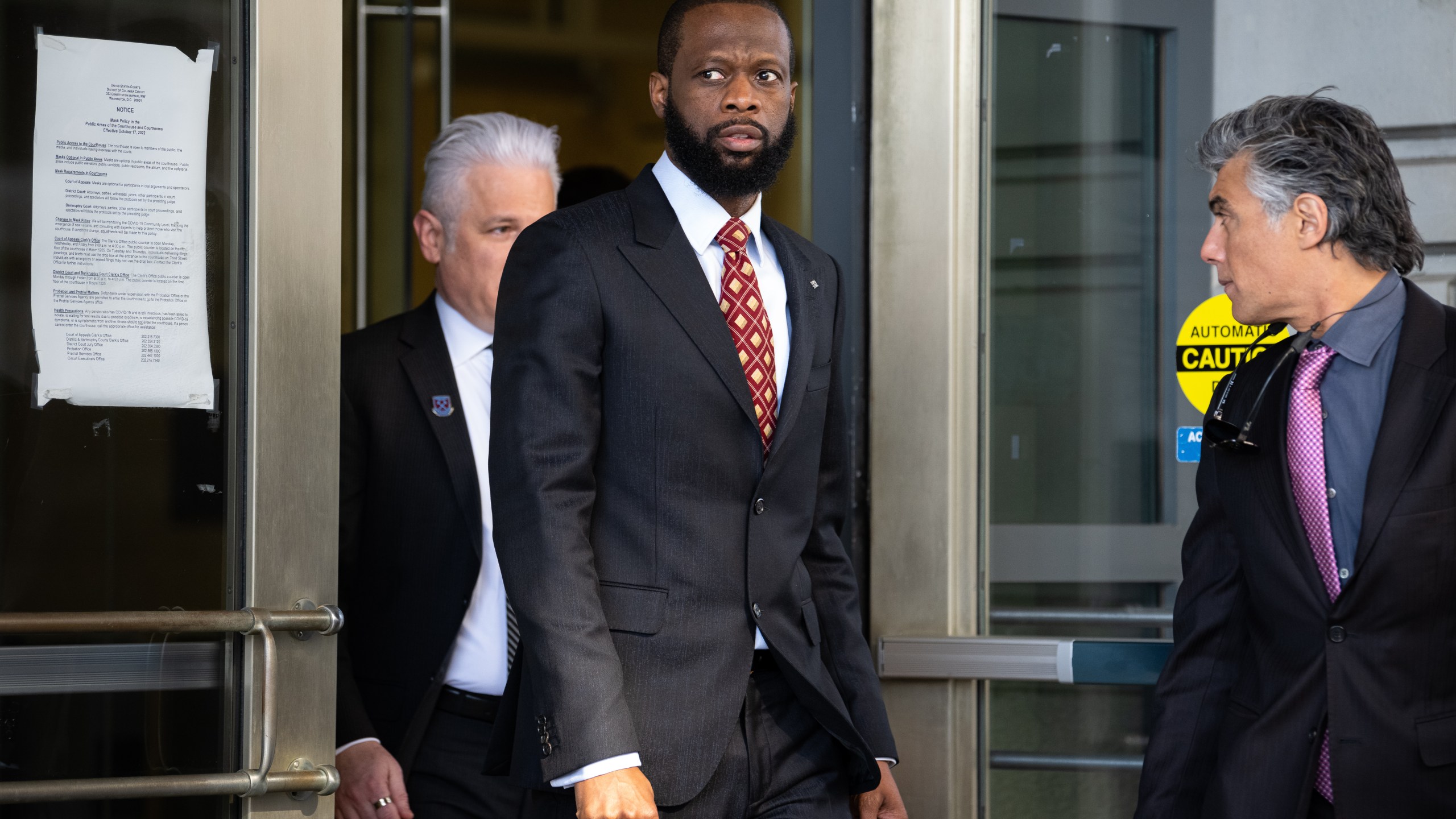 Pras Michel, former member of the Fugees, center, exits federal court