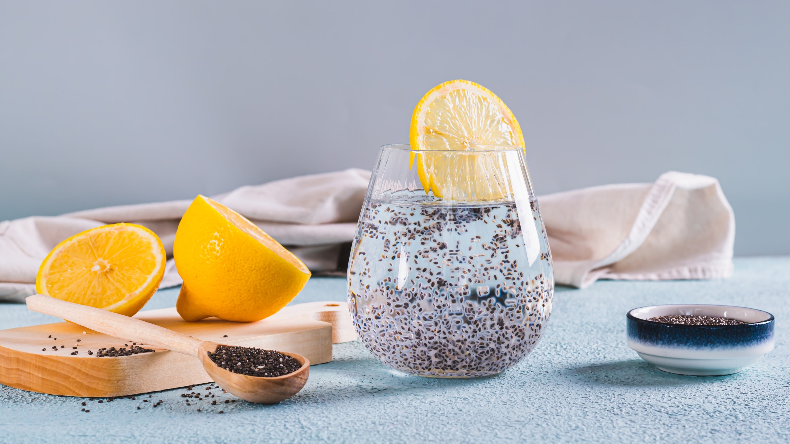 Chia seed water with lemon slice in a glass on the table