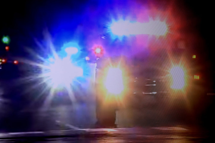 Flashing lights on police cars at night.
