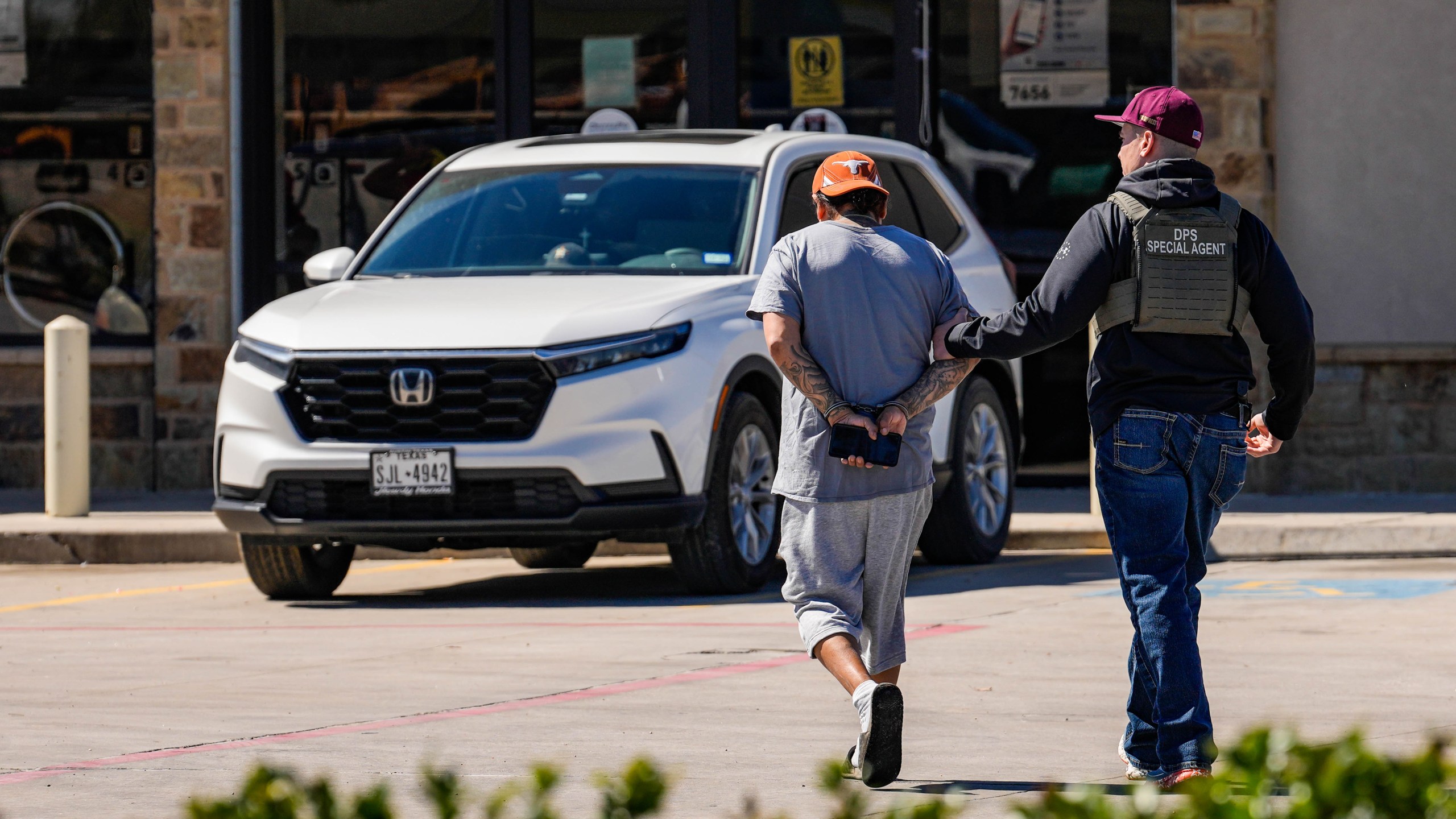 A man is detained by Federal agents