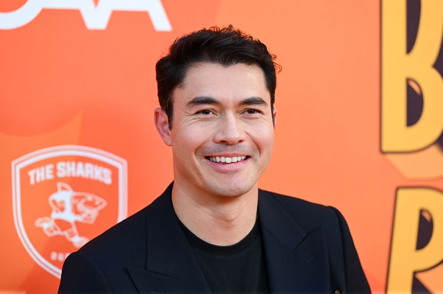 Henry Golding poses for photos at an event
