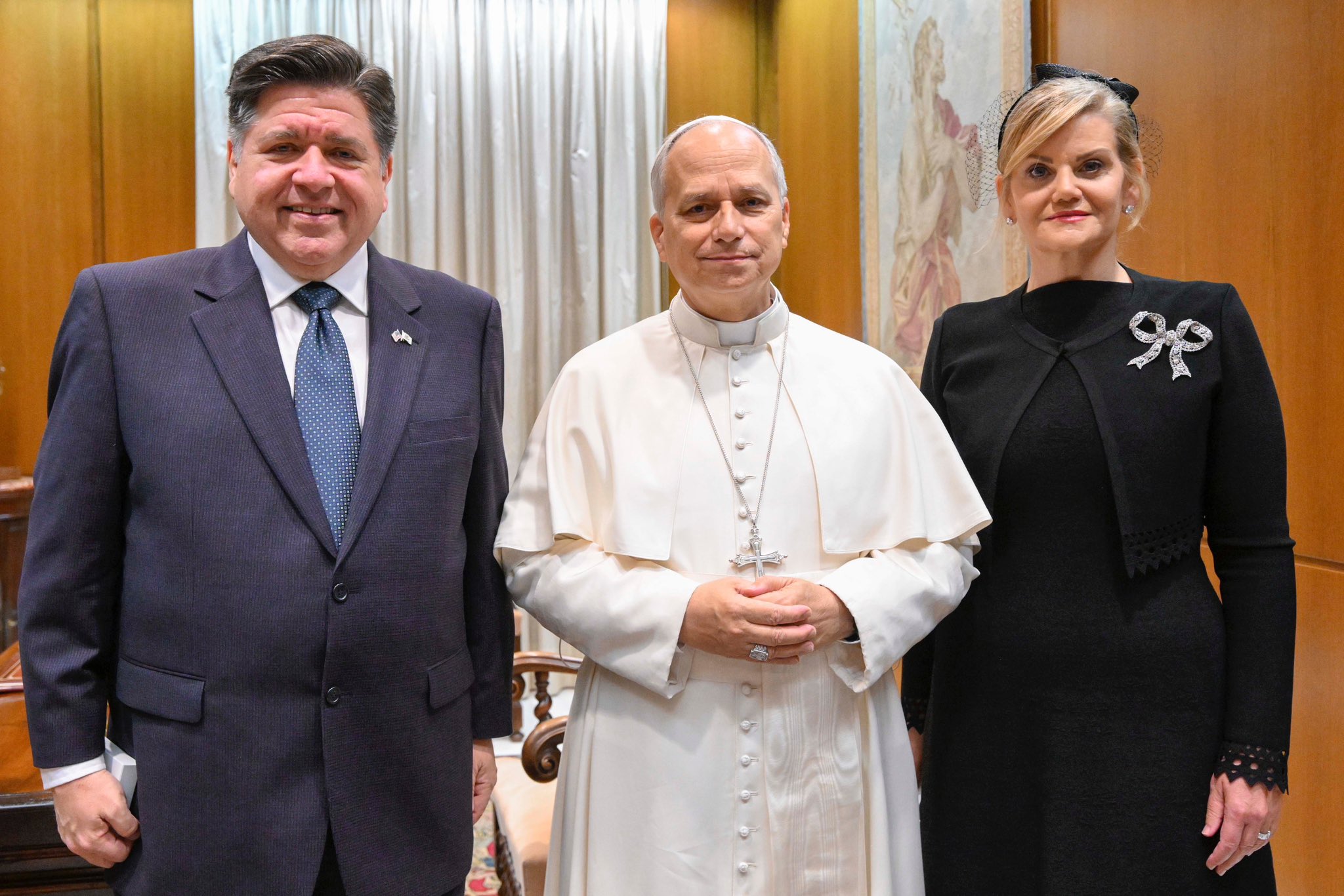 Illinois Governor JB Pritzker, First Lady MK Pritzker, and Pope Leo XIV stand and smile for a photo.