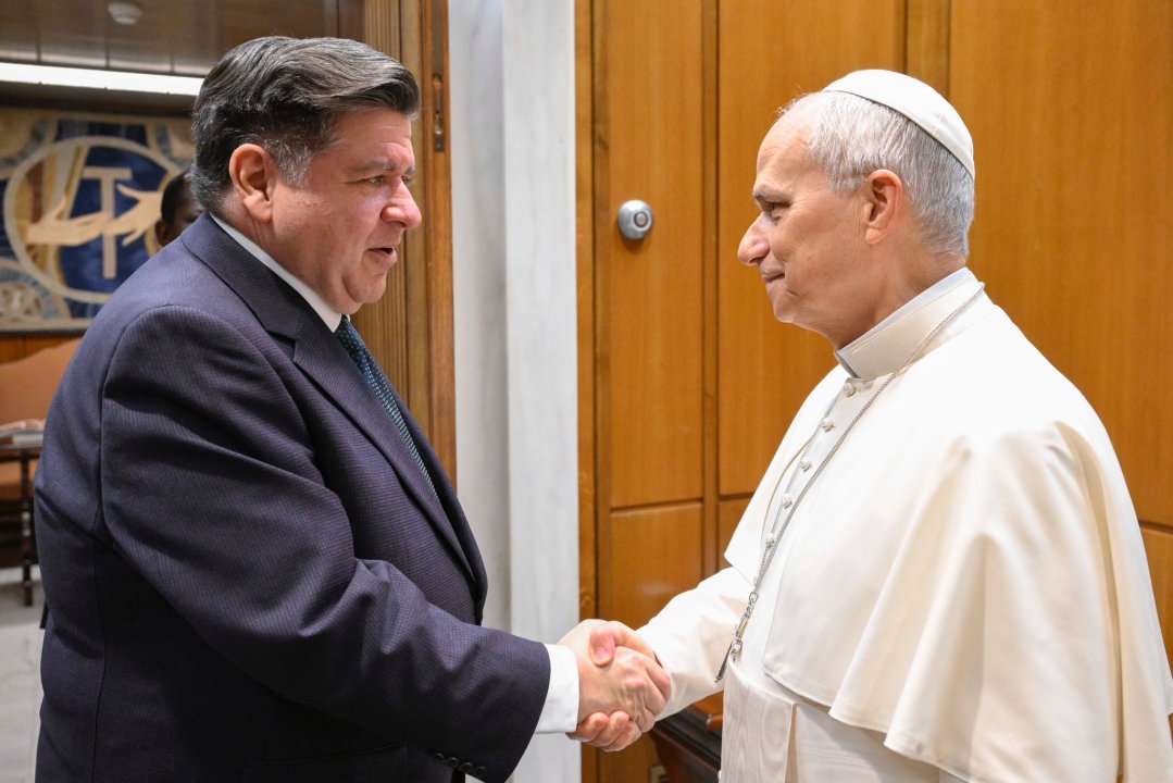 Pritzker and the pope shaking hands
