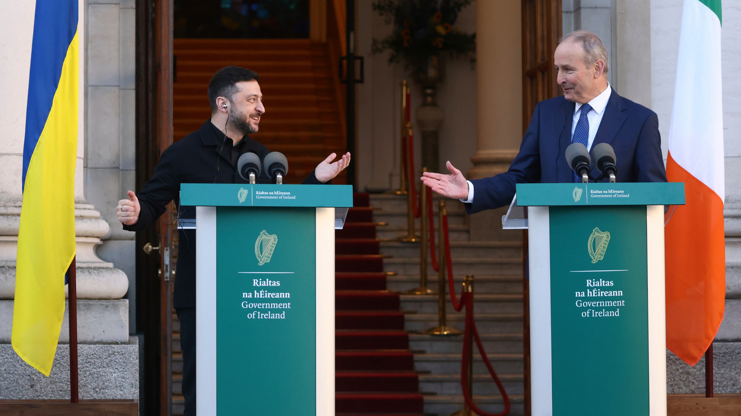 Ukraine's President Volodymyr Zelenskyy, left, and the Irish Prime Minister Micheal Martin gesture to each other as they take part in a joint press conference in Dublin, Ireland, Tuesday, Dec. 2, 2025. (AP Photo/Peter Morrison)