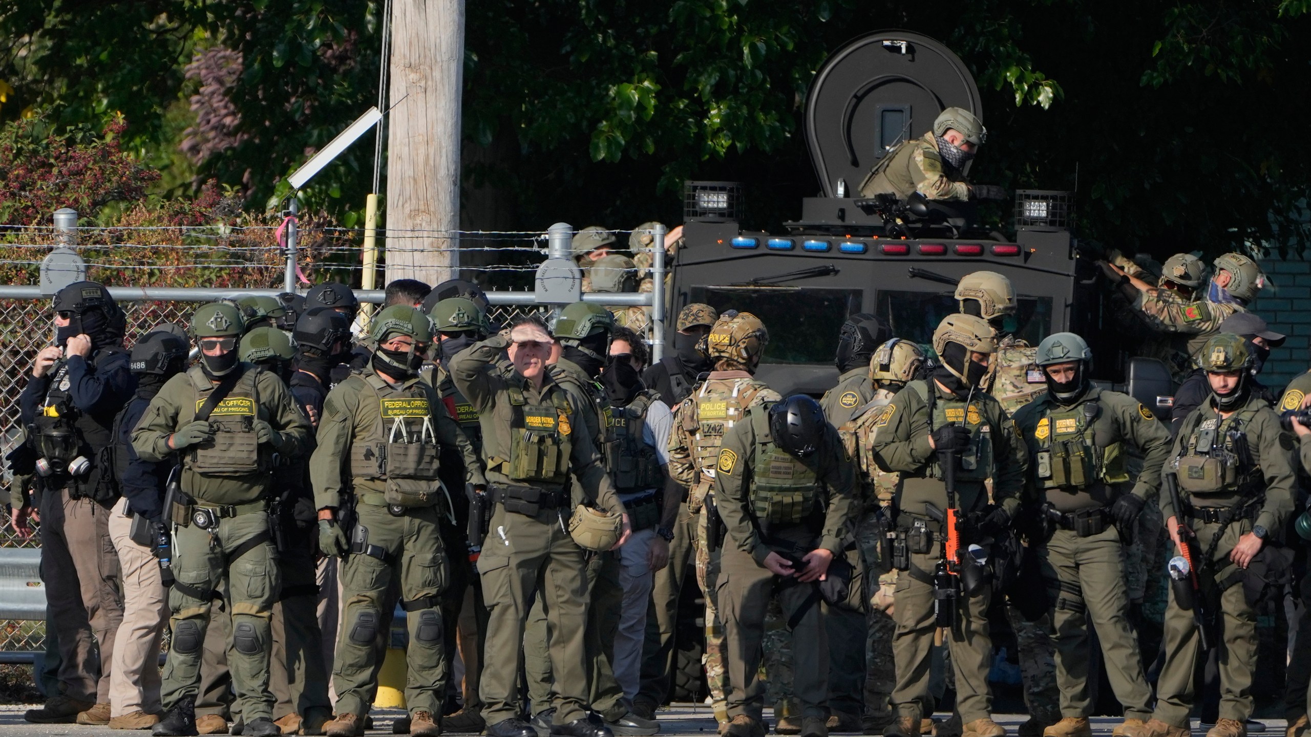 FILE - Greg Bovino, the chief patrol agent for the U.S. Border Patrol El Centro sector, center, stands with federal immigration agents near an Immigration and Customs Enforcement facility in Broadview, Ill., Oct. 3, 2025. (AP Photo/Erin Hooley, File)