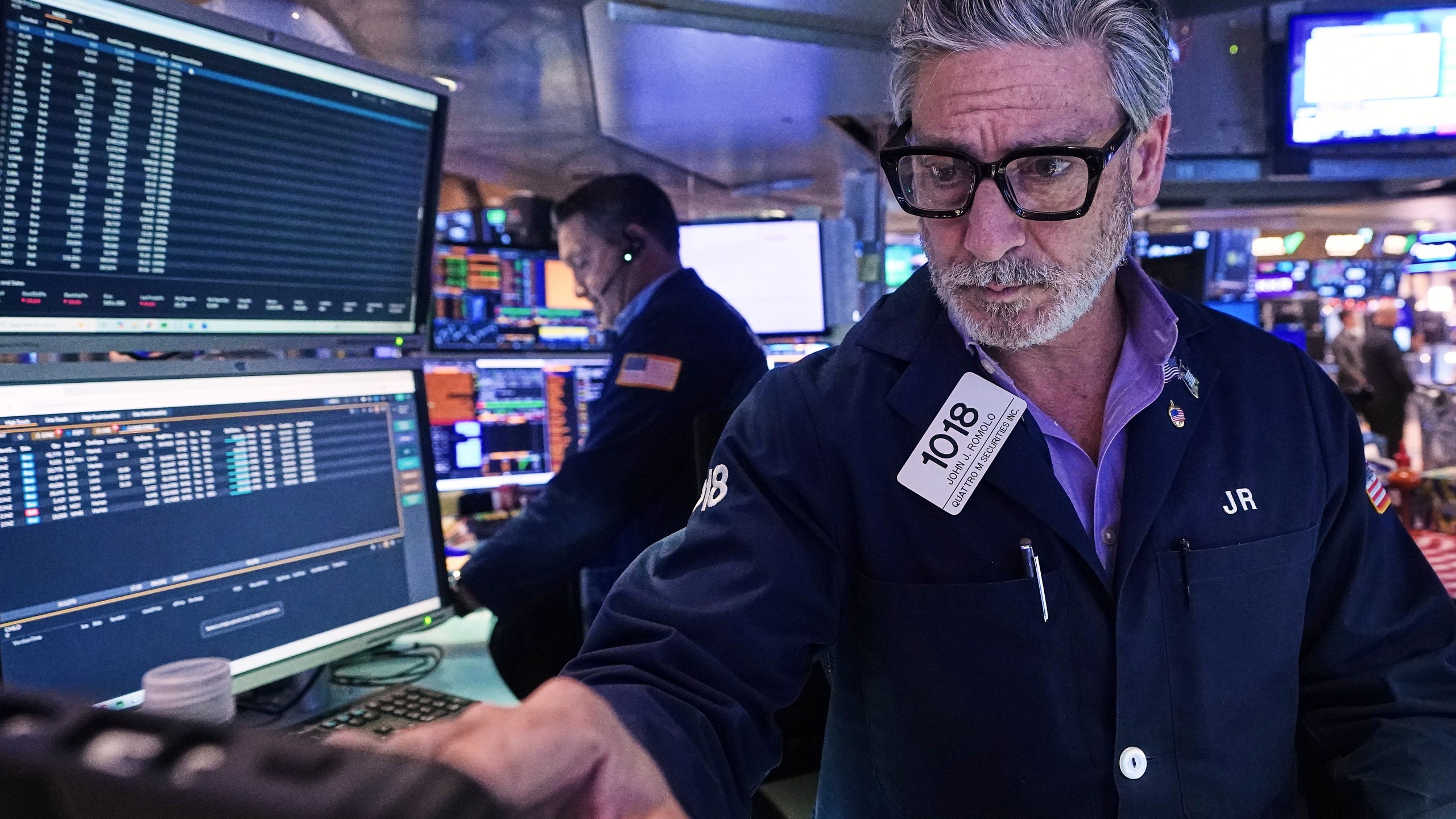 Trader John Romolo works on the floor of the New York Stock Exchange, Tuesday, Dec. 2, 2025. (AP Photo/Richard Drew)