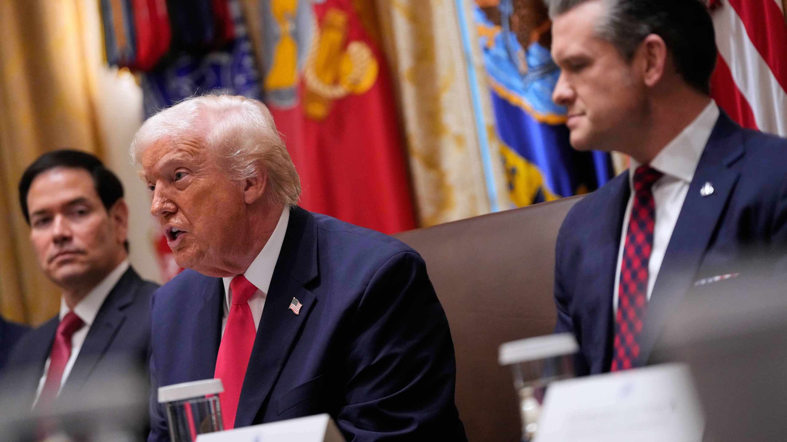 President Donald Trump speaks during a Cabinet meeting at the White House, Tuesday, Dec. 2, 2025, in Washington, as Secretary of State Marco Rubio and Defense Secretary Pete Hegseth, look on. (AP Photo/Julia Demaree Nikhinson)
