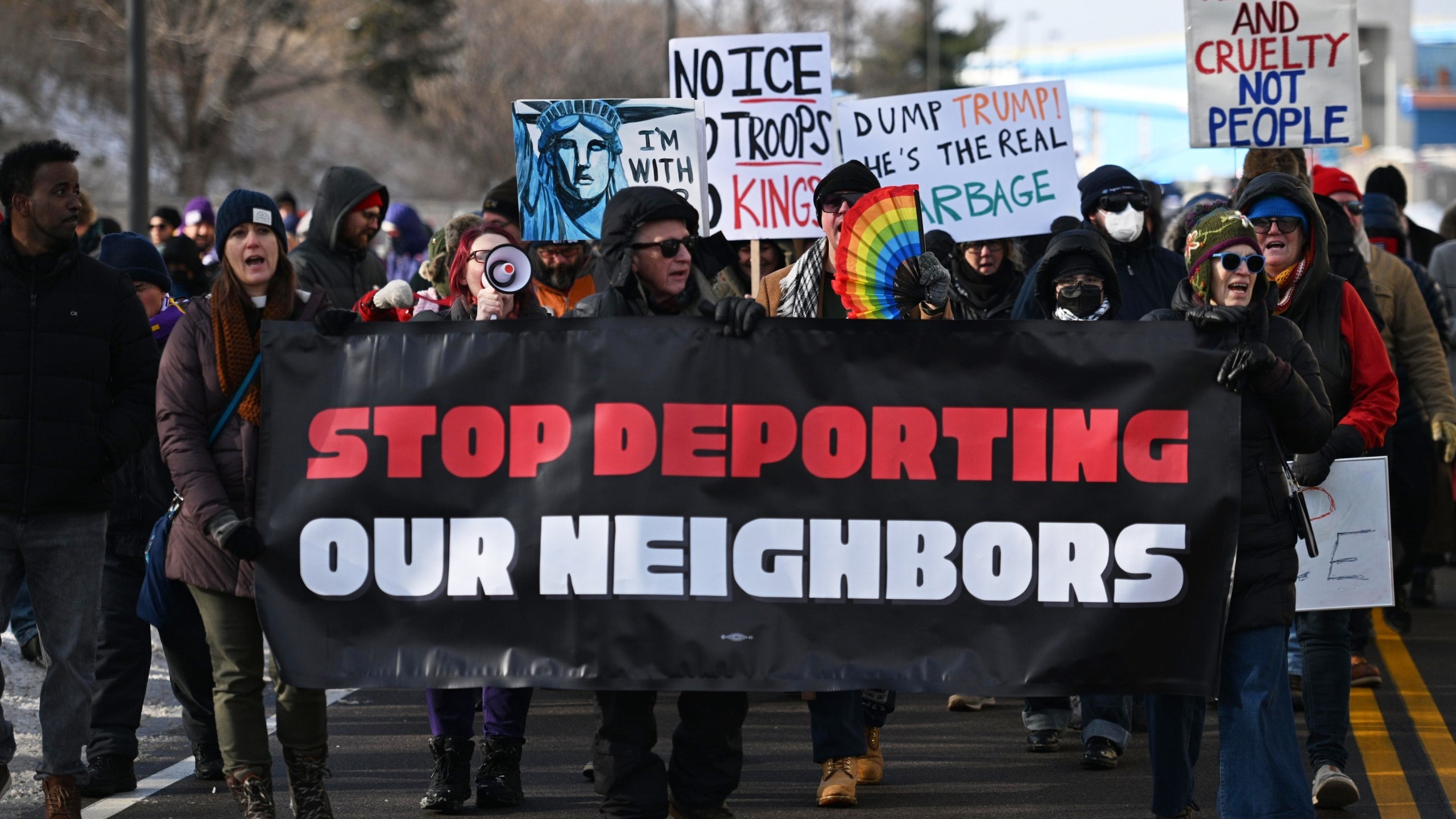 Protesters gather at a rally for immigrant and worker outside Signature Aviation near the Minneapolis–Saint Paul International Airport, Wednesday, Dec 3, 2025, in Minneapolis. (AP Photo/Tom Baker)