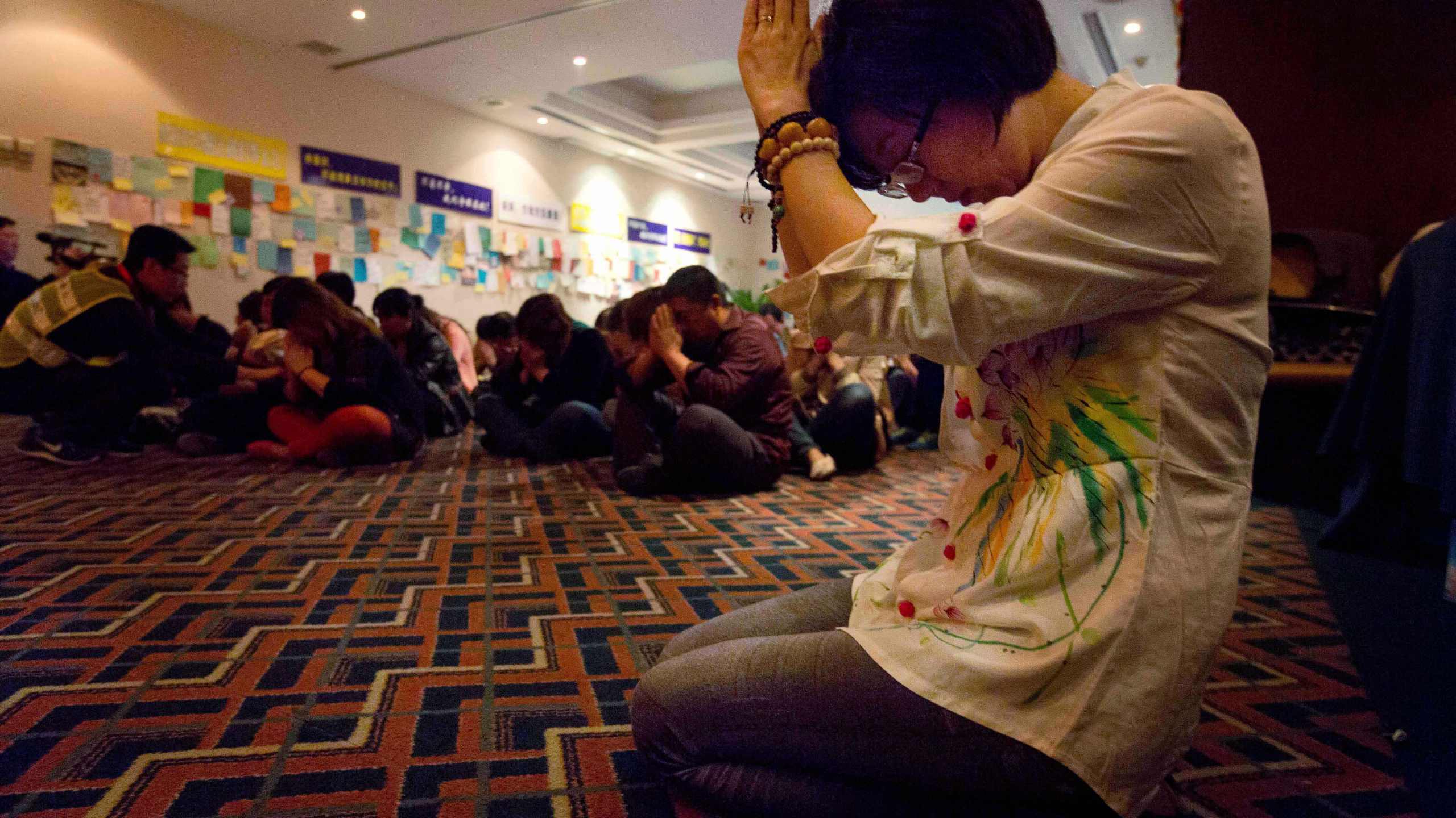 FILE -Relatives of Chinese passengers on board the Malaysia Airlines Flight MH370 pray at a prayer room in Beijing, China, April 4, 2014. (AP Photo/Ng Han Guan, File)