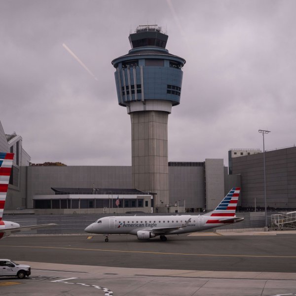 An American Eagle plane moves past an FAA Air Traffic Control tower
