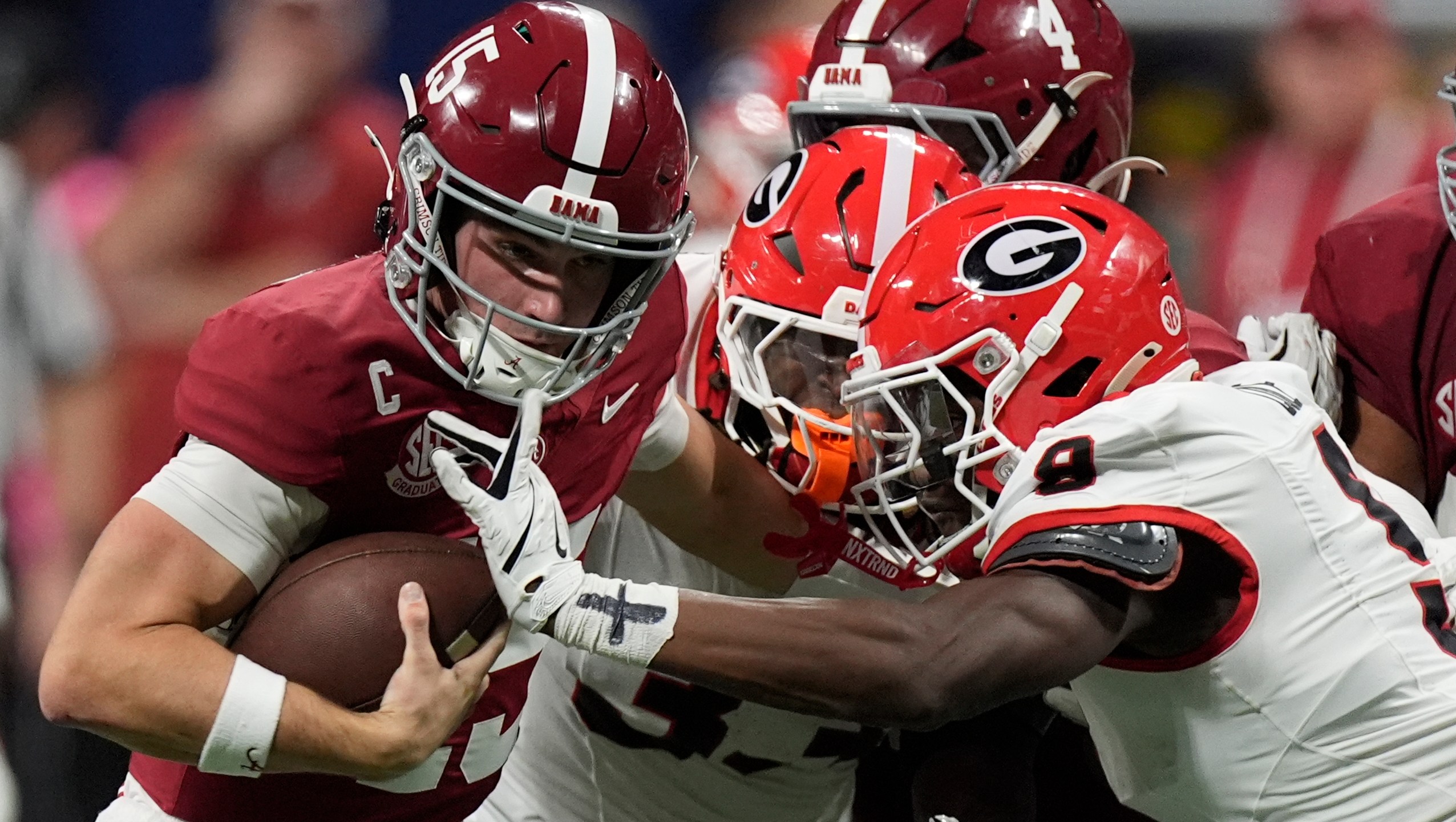 Alabama quarterback Ty Simpson (15) is tackles by Georgia linebacker Chris Cole (9) during the second half of a Southeastern Conference championship NCAA college football game, Saturday, Dec. 6, 2025, in Atlanta.