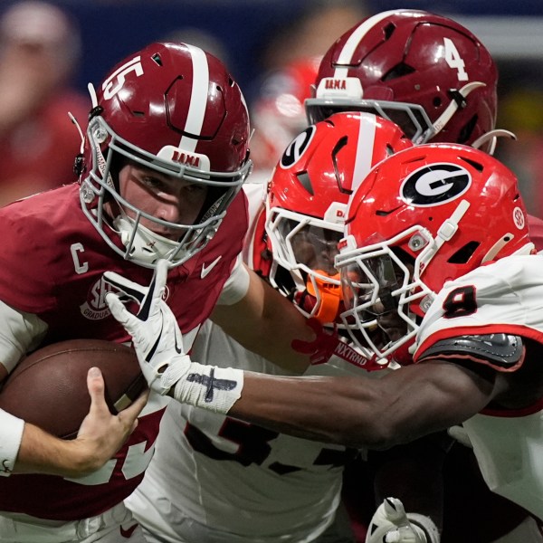 Alabama quarterback Ty Simpson (15) is tackles by Georgia linebacker Chris Cole (9) during the second half of a Southeastern Conference championship NCAA college football game, Saturday, Dec. 6, 2025, in Atlanta.
