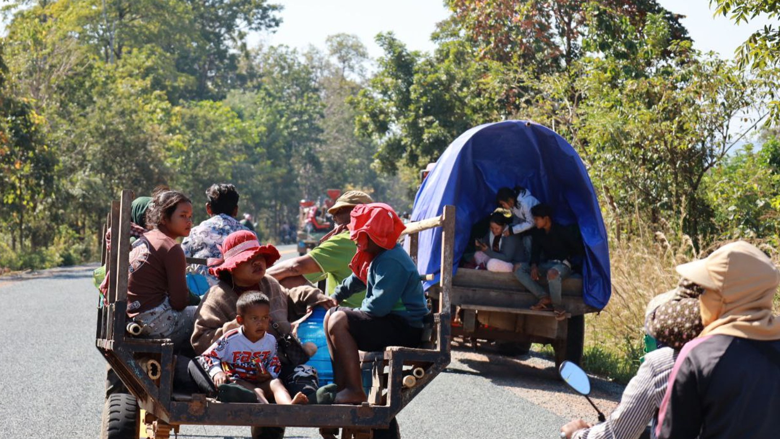 In this photo released by Agence Kampuchea Press (AKP), Cambodian villagers, transported by motor cart and tractor, flee from their home in Preah Vihear province, Cambodia, Monday, Dec. 8, 2025. (AKP via AP)