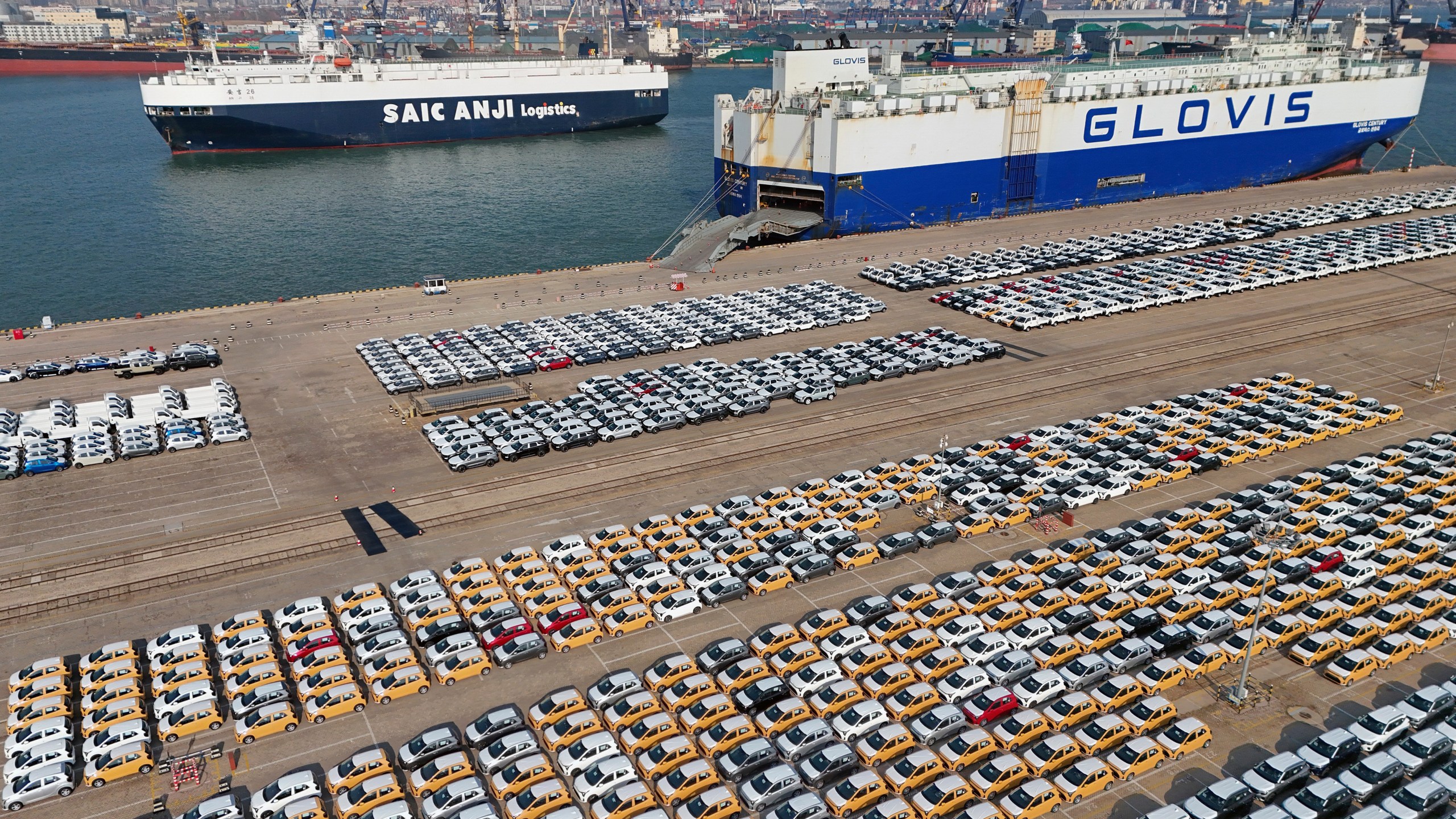 FILE - Vehicles and trucks for export wait for transportation from a port in Yantai in eastern China's Shandong province on Jan. 2, 2025. (Chinatopix via AP, File)
