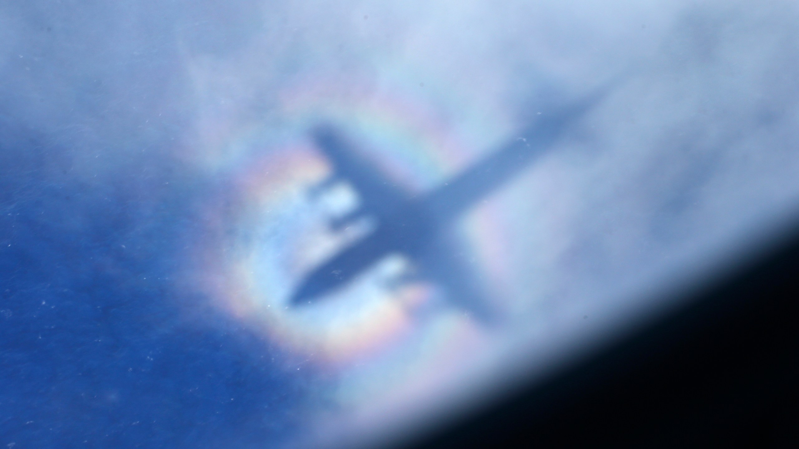 FILE -The shadow of a Royal New Zealand Air Force P3 Orion is seen on low level cloud while the aircraft searches for missing Malaysia Airlines Flight MH370 in the southern Indian Ocean, near the coast of Western Australia, March 31, 2014. (AP Photo/Rob Griffith, File)
