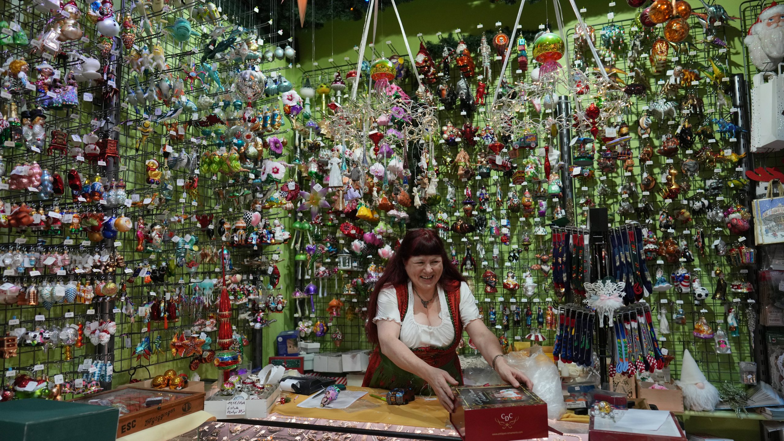 Owner of the Christel Dauwe Collection ornaments shop, Christel Dauwe, wraps boxes of holiday ornaments at her shop in Antwerp, Belgium, Monday, Dec. 8, 2025. (AP Photo/Virginia Mayo)