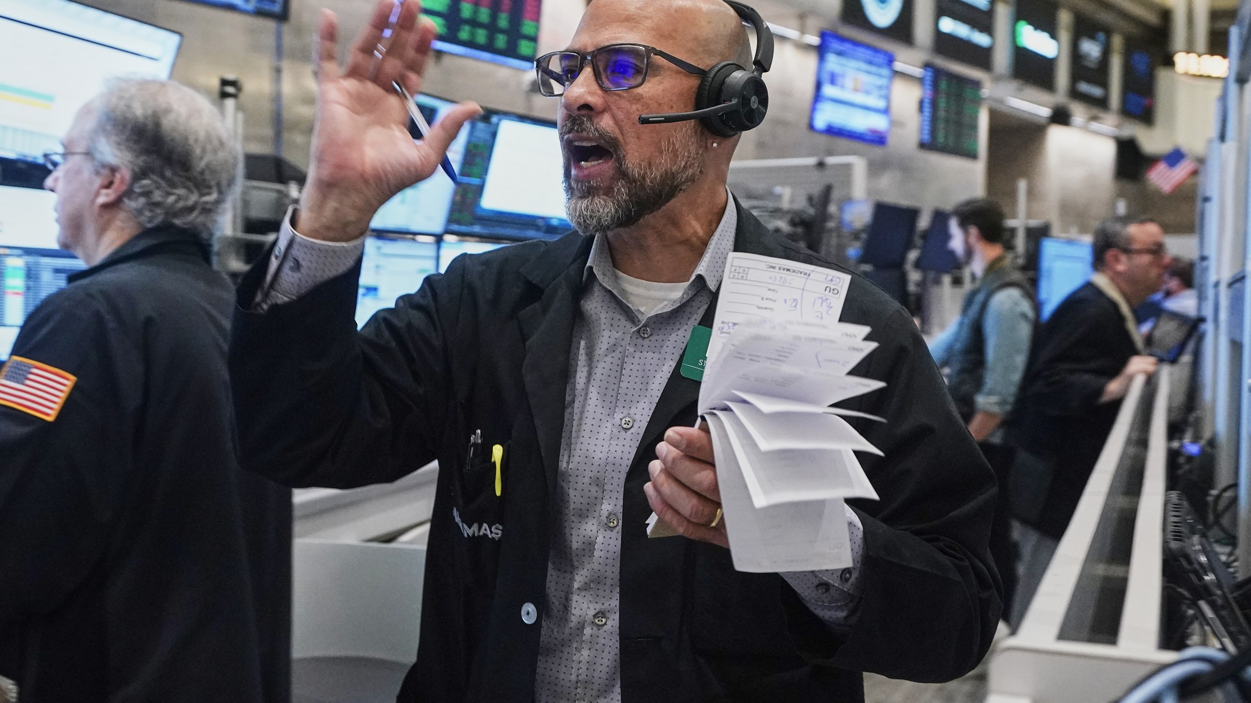 Options trader Steven Rodriguez works on the floor of the New York Stock Exchange, Friday, Nov. 21, 2025. (AP Photo/Richard Drew)