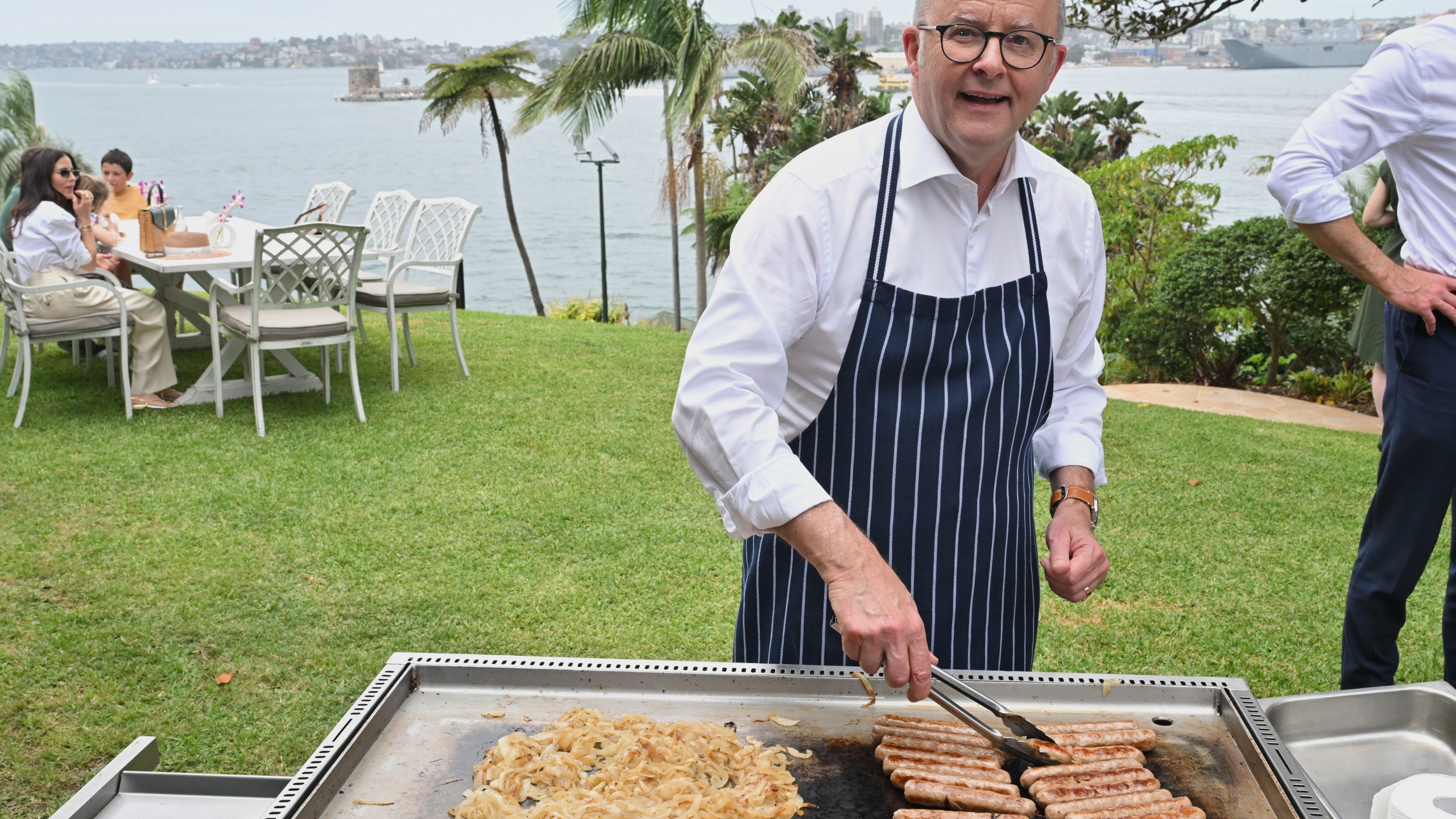 Australian Prime Minister Anthony Albanese reacts as he cooks on a barbecue at an event to mark the beginning of the social media ban for children under 16 years of age, at Kirribilli House, in Sydney, Australia, Wednesday, Dec. 10, 2025. (Mick Tsikas/AAP Image via AP)
