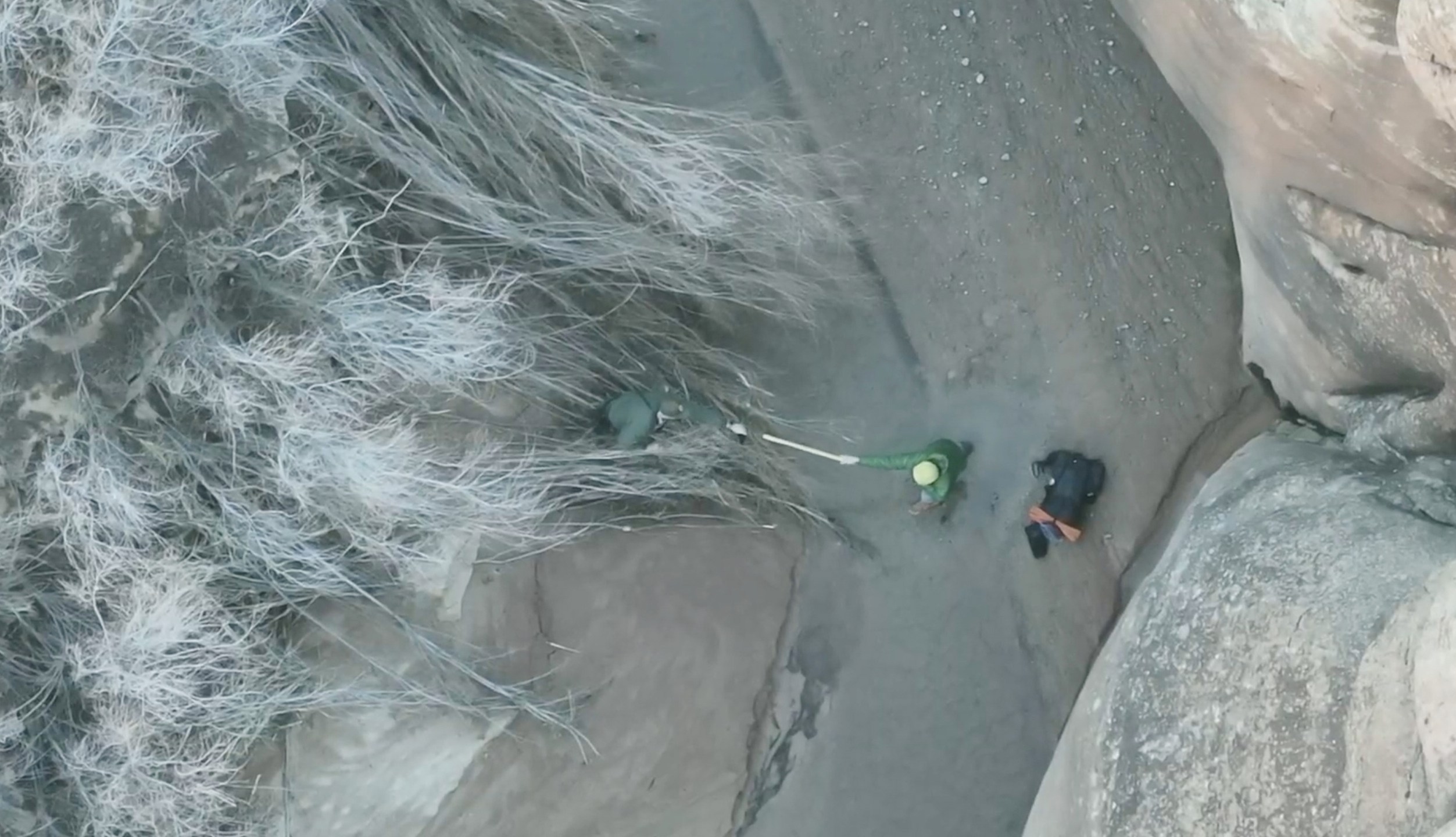 This image taken from drone footage provided by Grand County Search and Rescue shows a man, right, stuck in quicksand on Sunday, Dec. 7, 2025 in Arches National Park in eastern Utah.