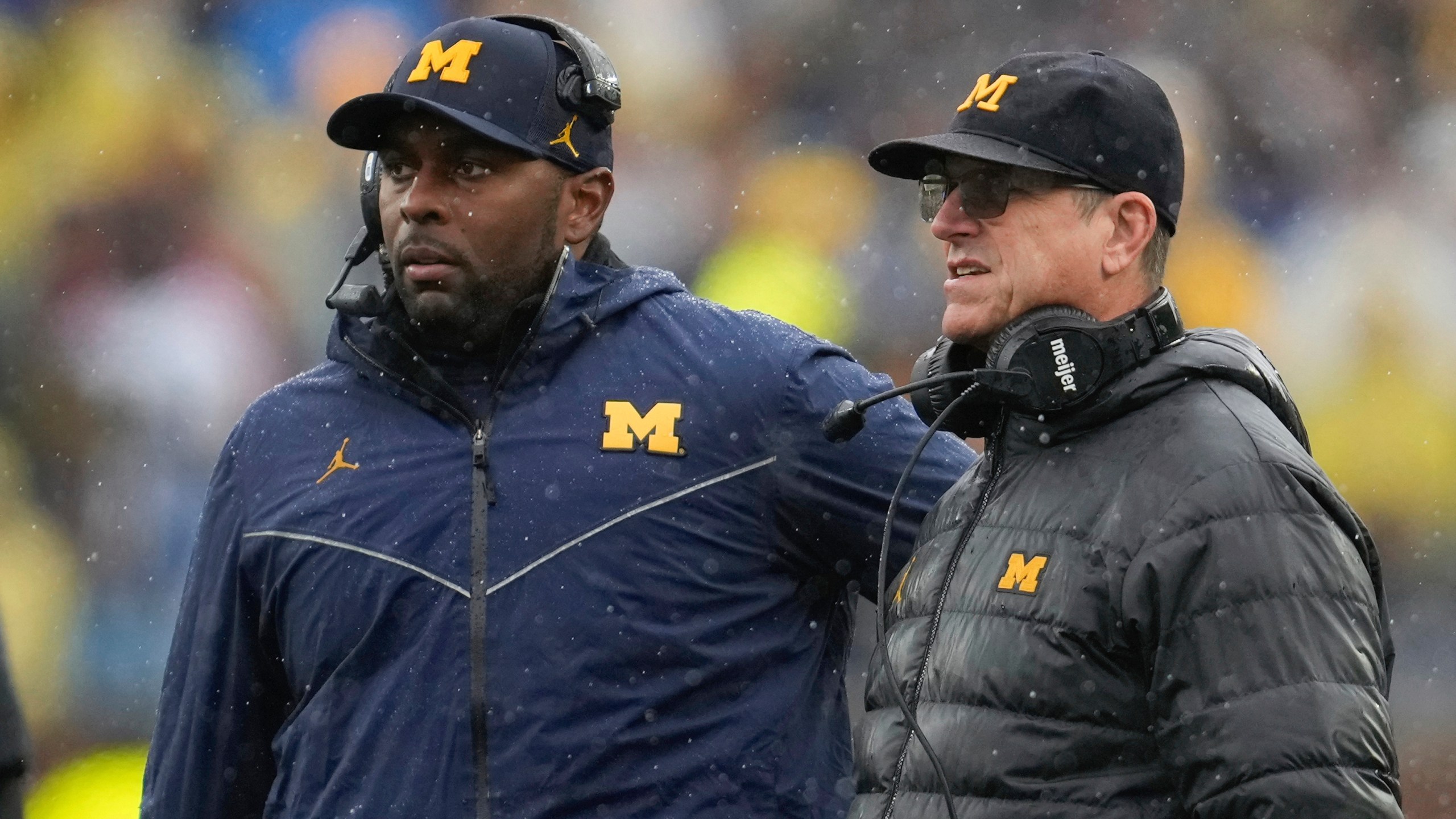 FILE - Michigan offensive coordinator Sherrone Moore, left, and coach Jim Harbaugh watch the team's play against Indiana during an NCAA college football game in Ann Arbor, Mich., Oct. 14, 2023. (AP Photo/Paul Sancya)