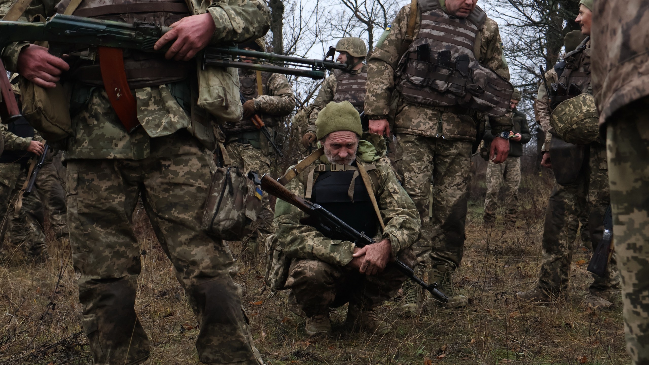 In this photo provided by Ukraine's 65th Mechanized Brigade press service, recruits rest after drills at a training ground in the Zaporizhzhia region, Ukraine, Friday, Dec. 12, 2025. (Andriy Andriyenko/Ukraine's 65th Mechanized Brigade via AP)