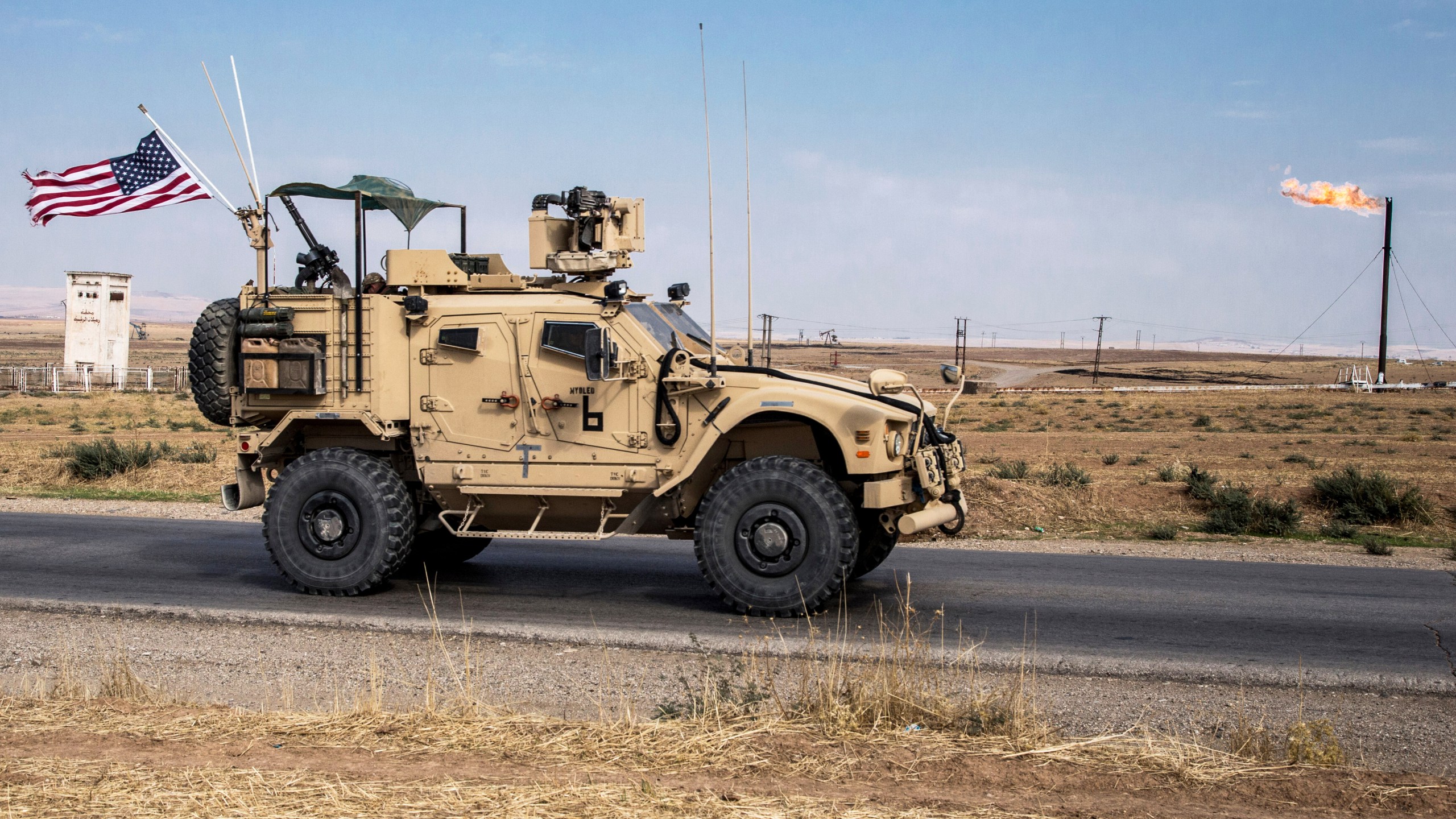 FILE - U.S. forces patrol oil fields in Syria, Oct. 28, 2019 . (AP Photo/Baderkhan Ahmad, File)