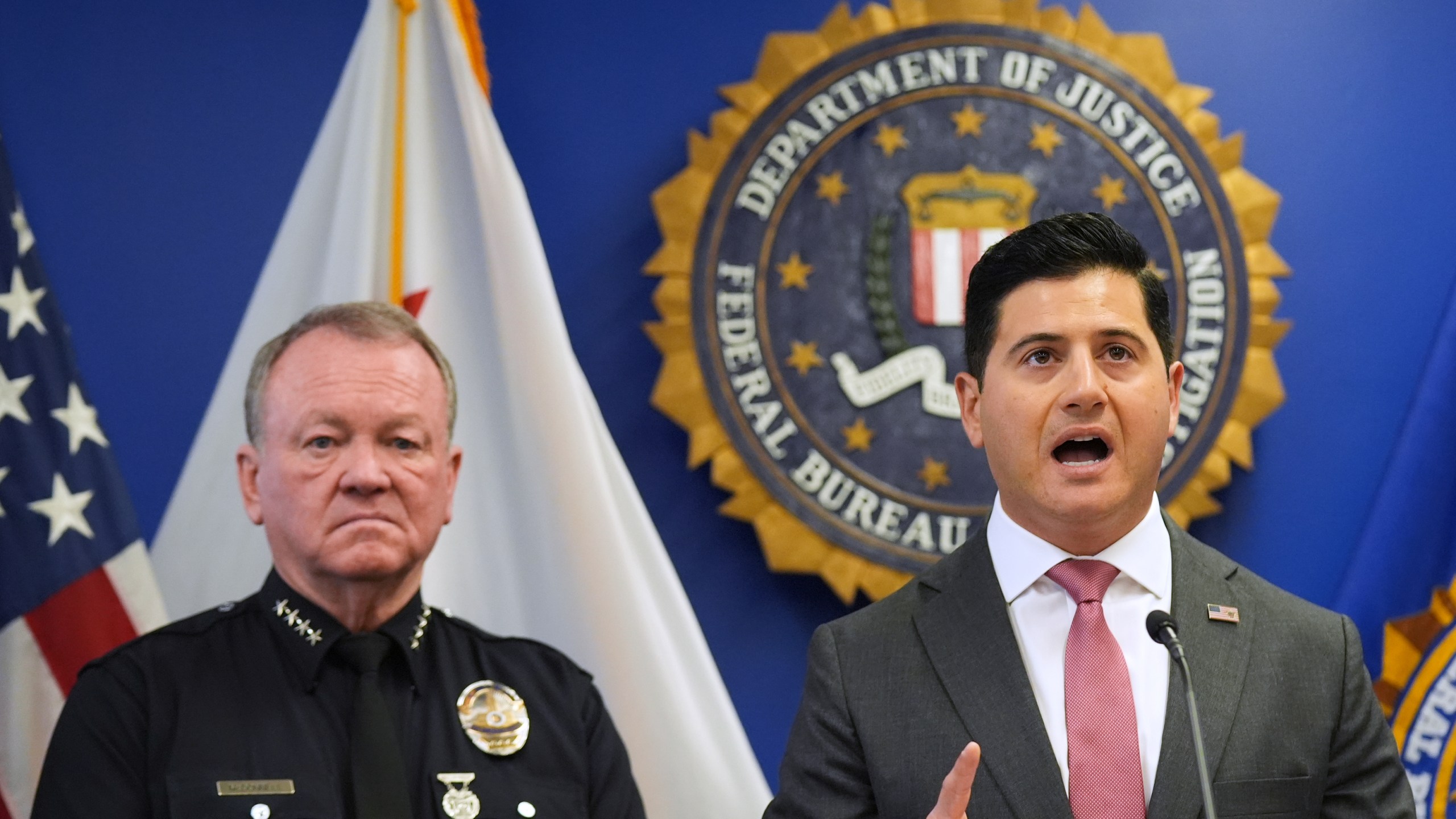 First Assistant United States Attorney Bill Essayli, right, speaks in front of LAPD Chief Jim McDonnell during a press conference announcing developments on a terrorism investigation Monday, Dec. 15, 2025, in Los Angeles. (AP Photo/Damian Dovarganes)