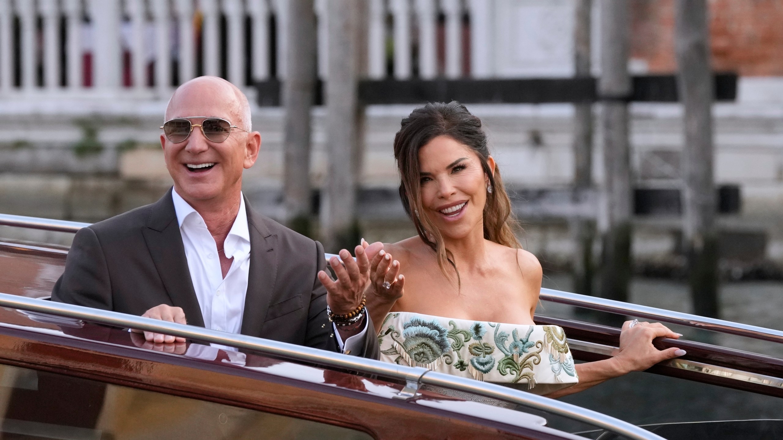 FILE - Jeff Bezos, left, and Lauren Sanchez leave a hotel for their pre wedding reception, in Venice, Italy, Thursday, June 26, 2025. (AP Photo/Luca Bruno, File)