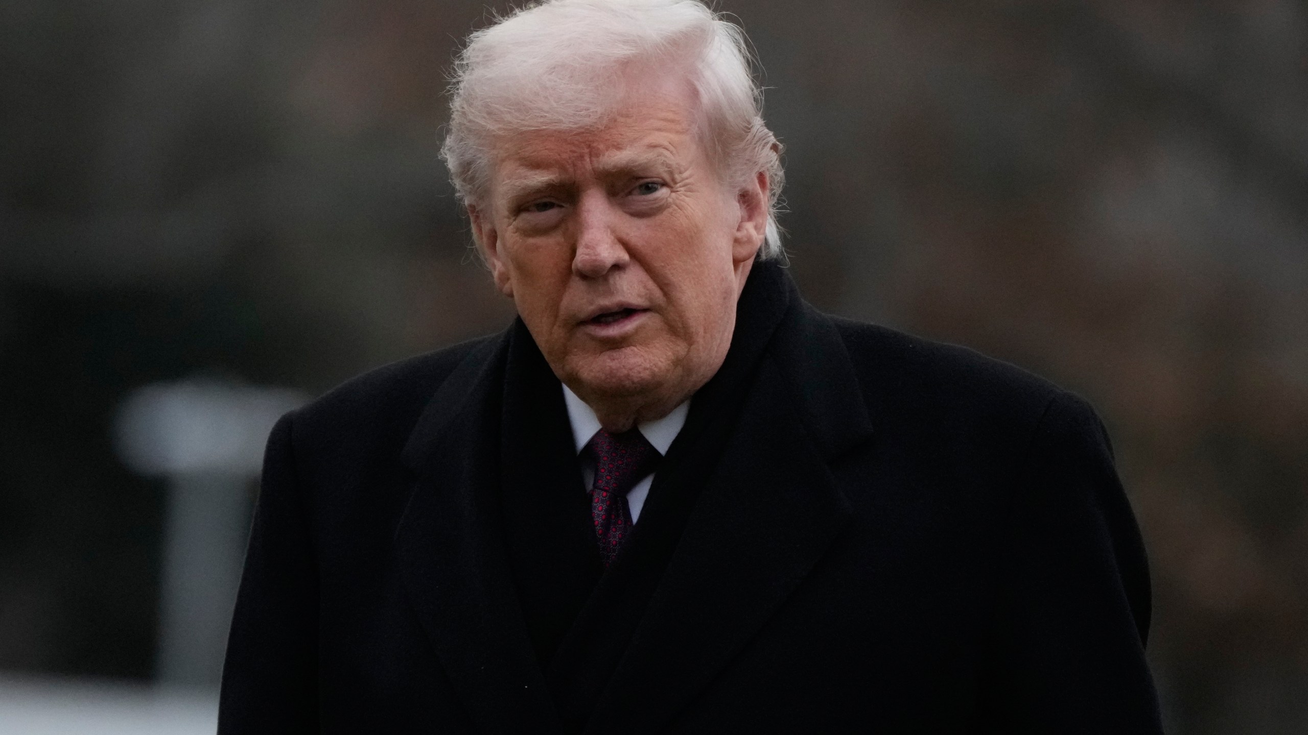 President Donald Trump looks over after stepping off Marine One on the South Lawn of the White House, Wednesday, Dec. 17, 2025, in Washington. (AP Photo/Mark Schiefelbein)