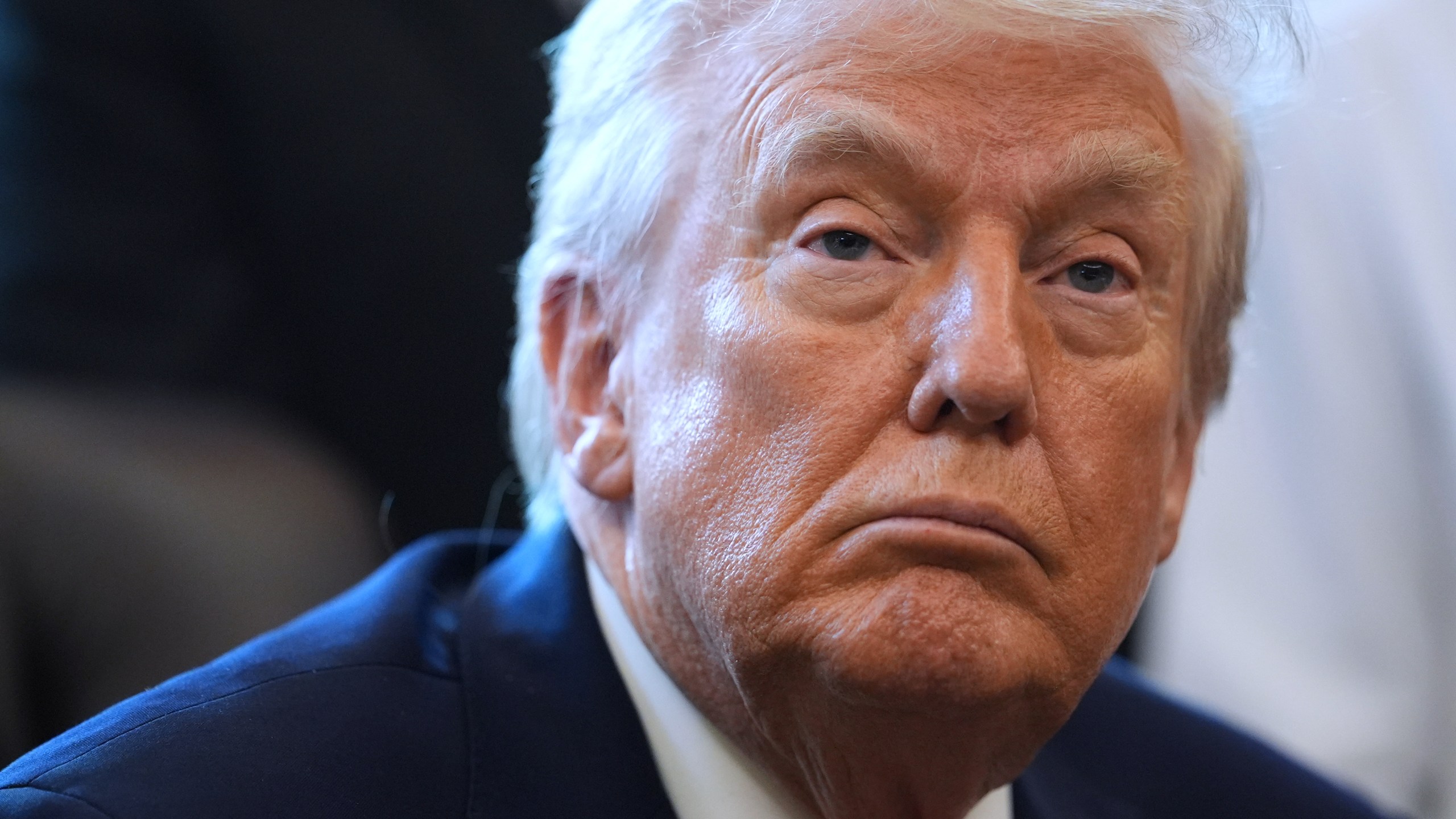 President Donald Trump listens before he signs an executive order reclassifying marijuana as a less dangerous drug in the Oval Office of the White House, Thursday, Dec. 18, 2025, in Washington. (AP Photo/Evan Vucci)