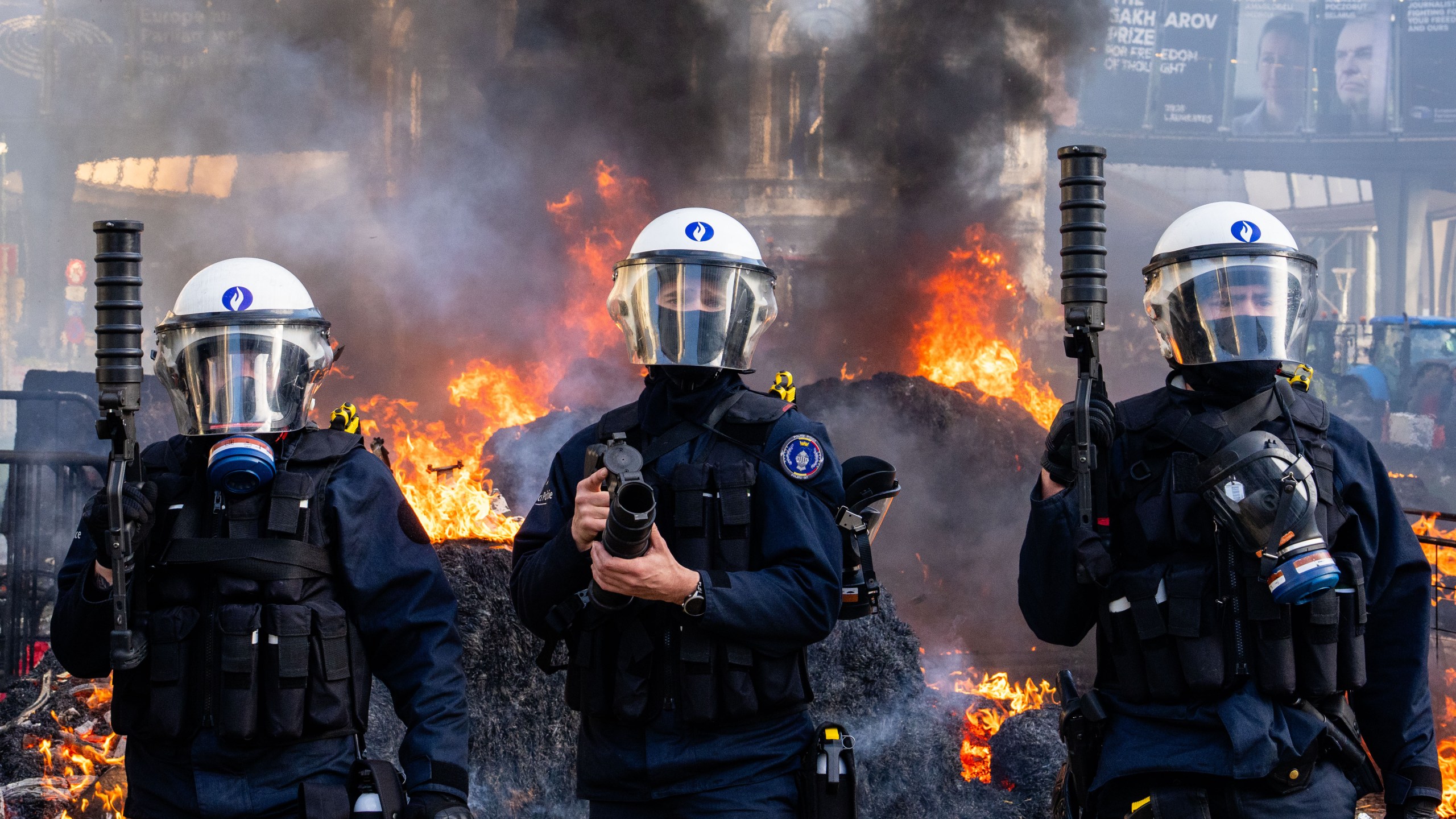 Police try to disperse protestors during a demonstration of European farmers near the European Parliament in Brussels, Thursday, Dec. 18, 2025. (AP Photo/Marius Burgelman)