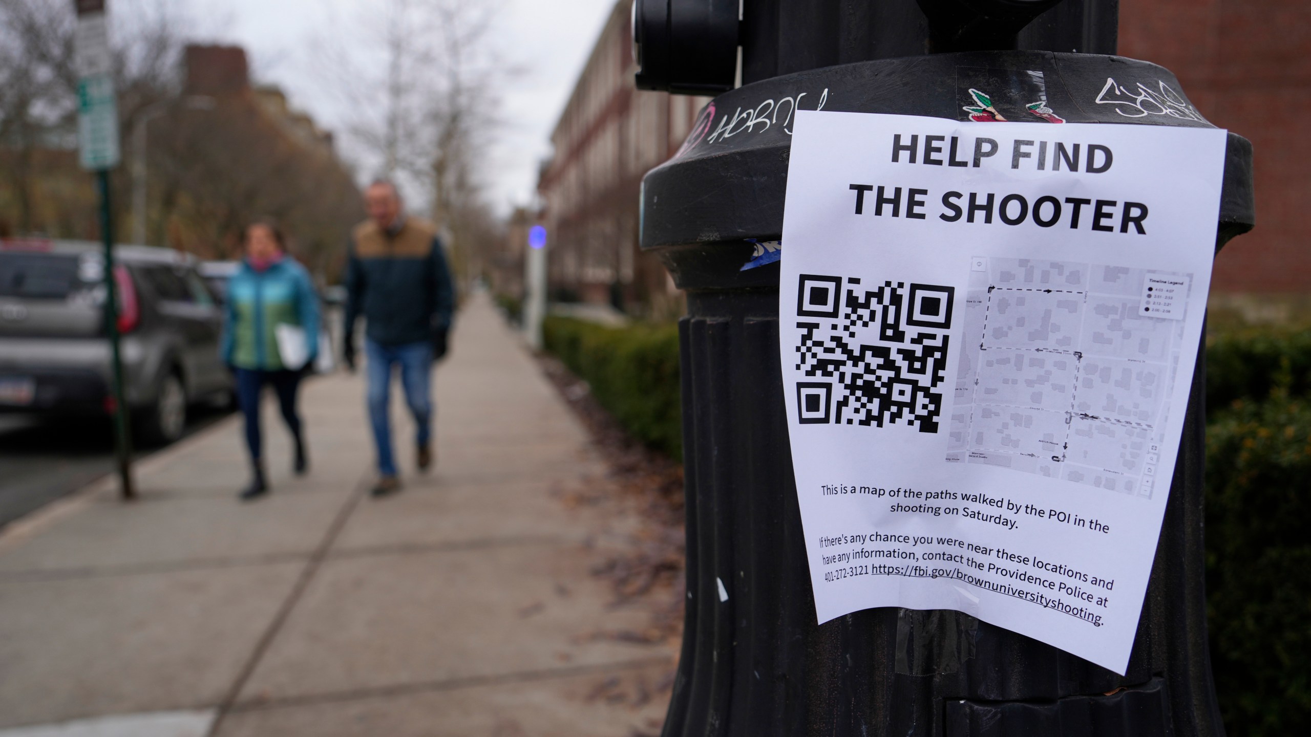 A poster seeking information about the campus shooting suspect is seen on the campus of Brown University, Wednesday, Dec. 17, 2025, in Providence, R.I. (AP Photo/Robert F. Bukaty)