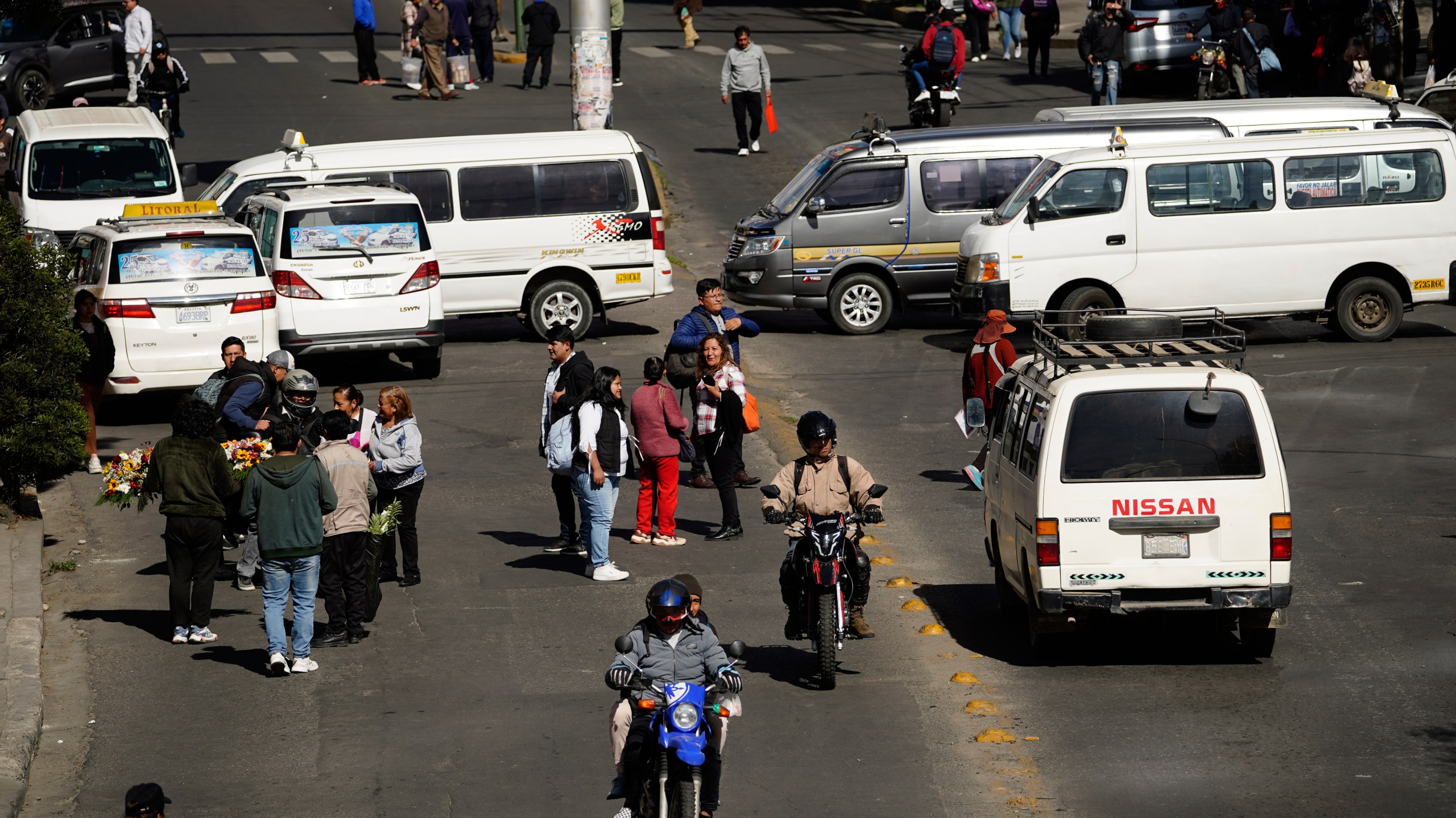 People walk during strike by the public transportation sector in La Paz, Bolivia, Friday, Dec. 19, 2025, after President Rodrigo Paz announced the end of fuel subsidies. (AP Photo/Freddy Barragan)
