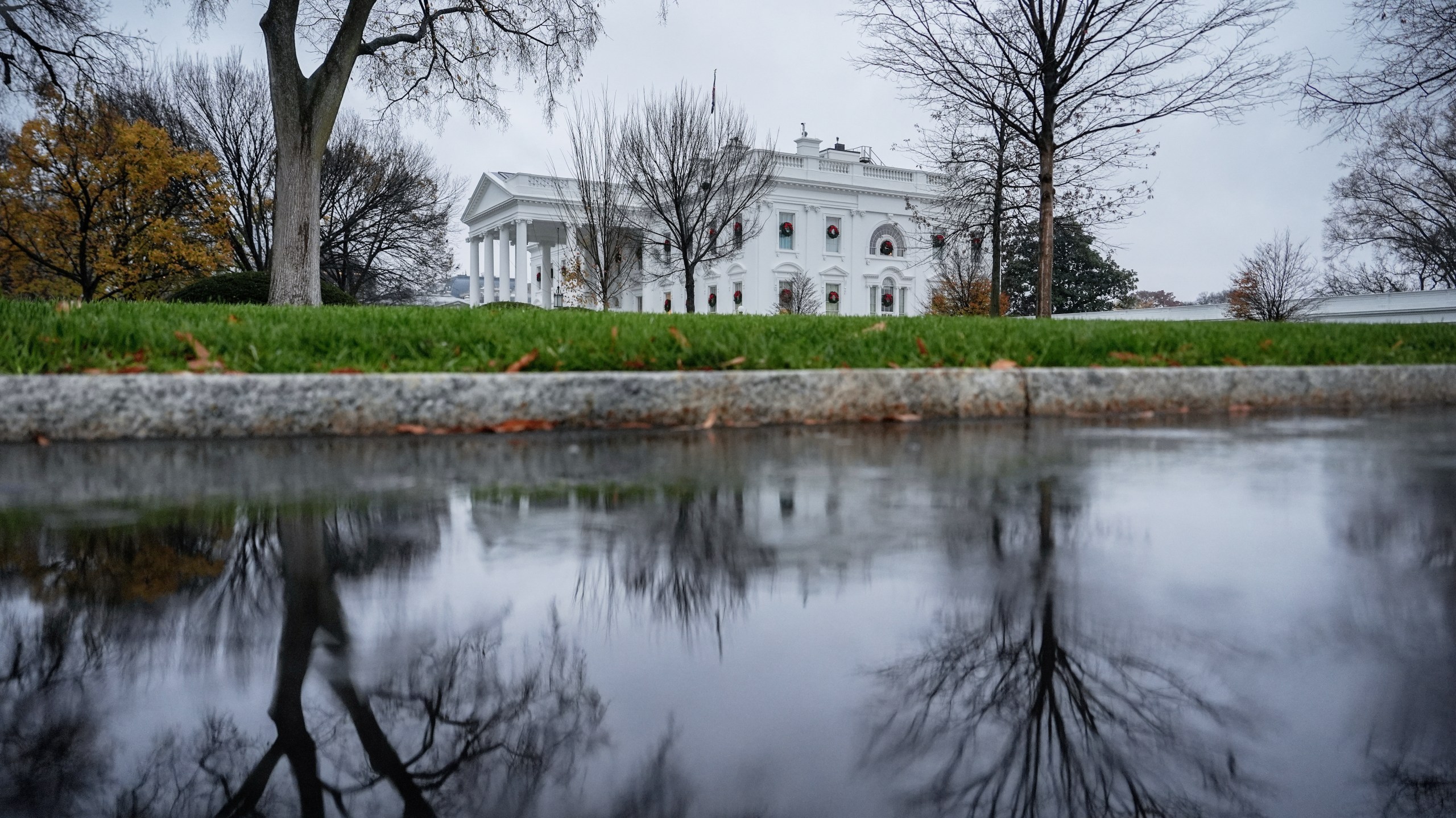 FILE - The White House is reflected in a puddle, Dec. 2, 2025, in Washington. (AP Photo/Julia Demaree Nikhinson, File)