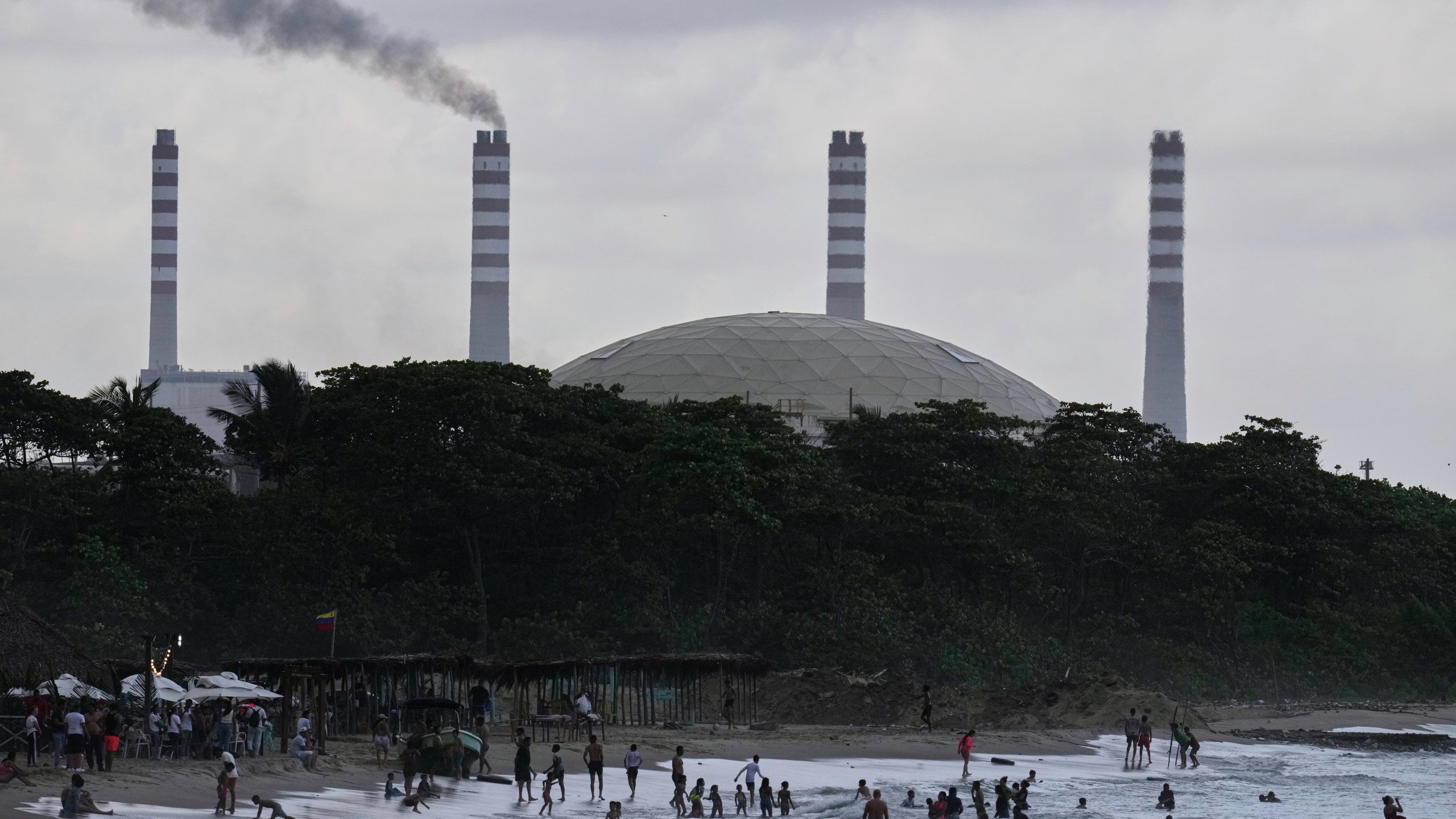 The El Palito refinery rises above a beach in Puerto Cabello, Venezuela, Sunday, Dec. 21, 2025. (AP Photo/Matias Delacroix)