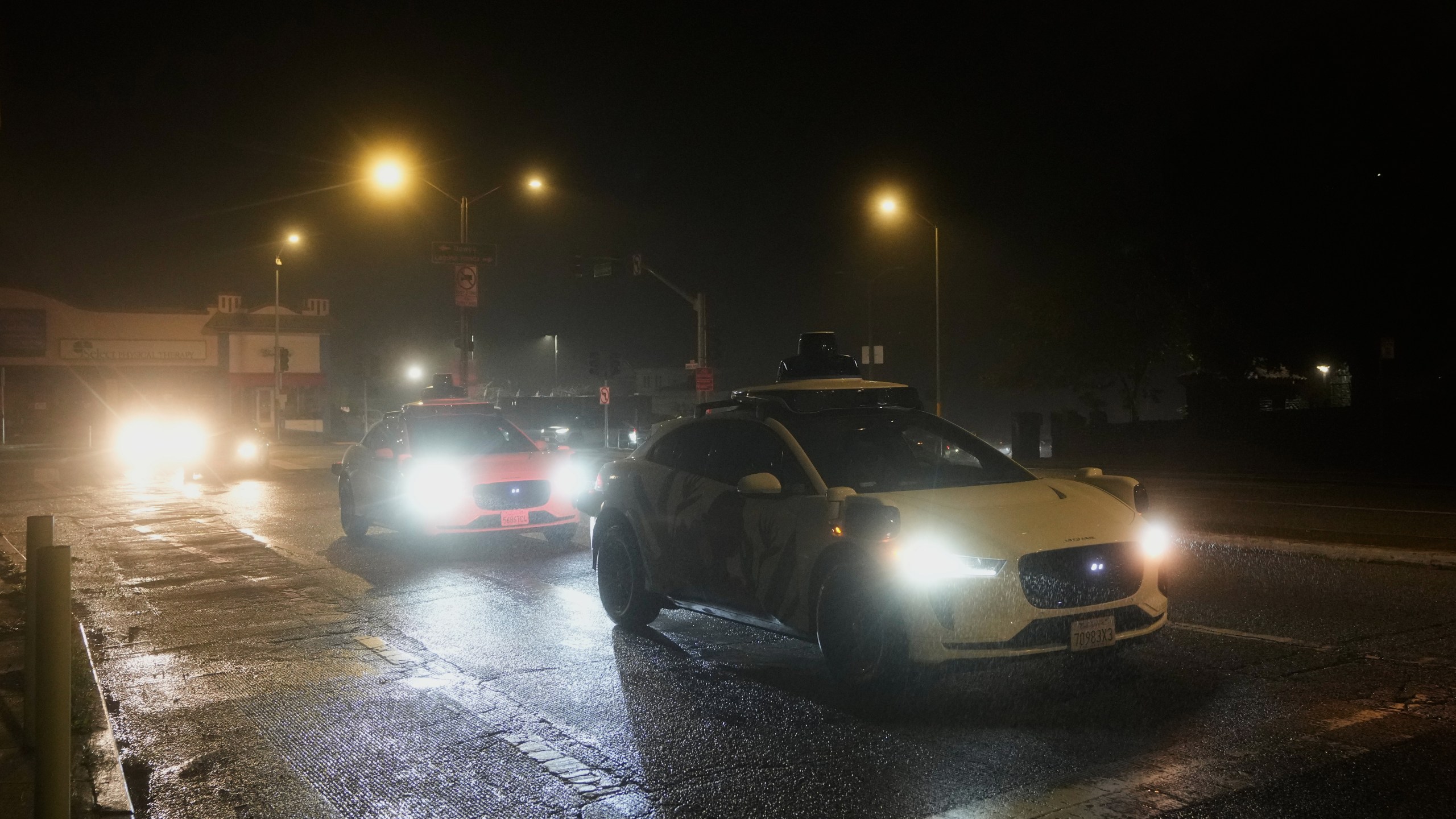 A Waymo vehicle sits idling at an intersection with no operating traffic lights due to power outages, in San Francisco, Saturday, Dec. 20, 2025. (AP Photo/Jeff Chiu)