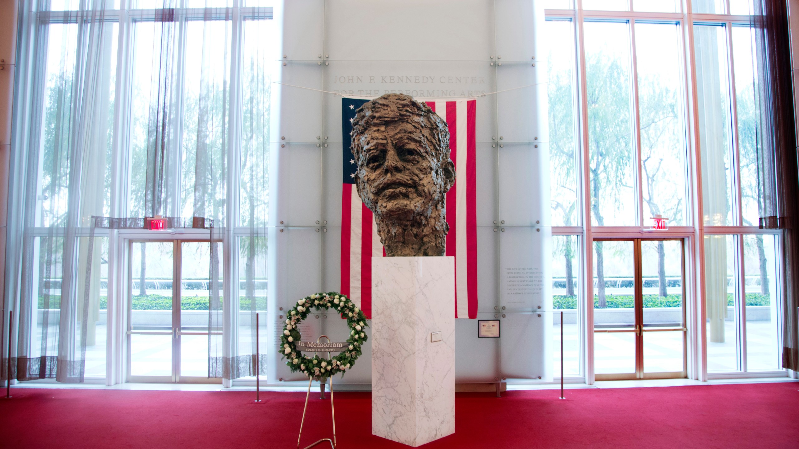 FILE - A memorial wreath stands next to the bronze memorial bust by Robert Berks of President John F. Kennedy in the grand foyer at the John F. Kennedy Center for the Performing Arts in Washington, Nov. 22, 2013, on the 50th anniversary of Kennedy's death. (AP Photo/Carolyn Kaster, File)
