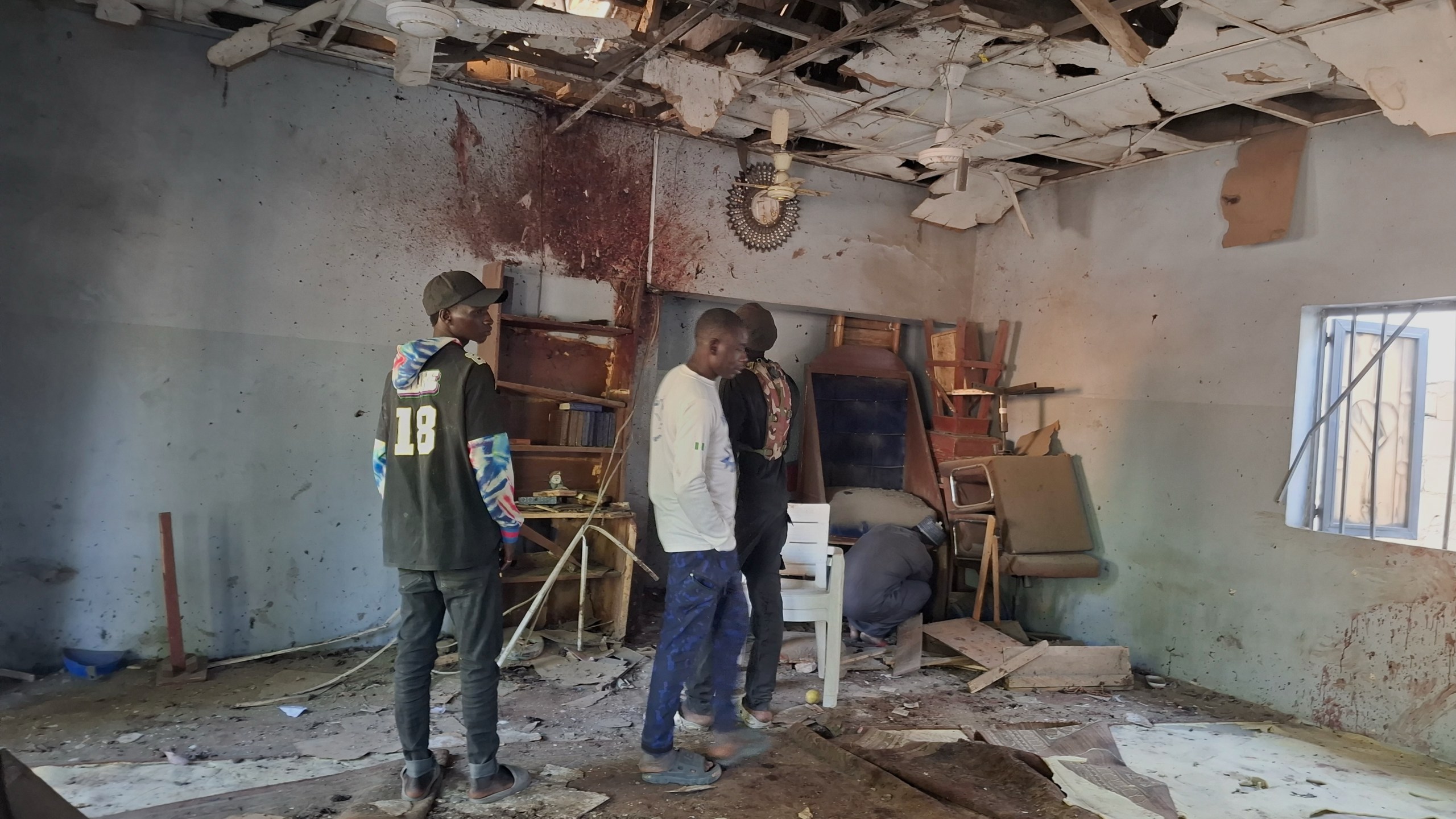People inspect the scene of a deadly bomb explosion inside a mosque in Maiduguri, Nigeria, Thursday, Dec. 25, 2025. (AP Photo/Jossy Ola )