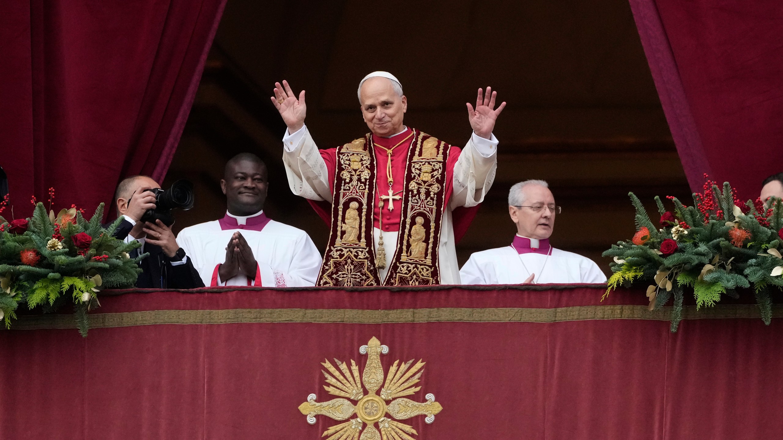 Pope Leo XIV waves after delivering the Urbi et Orbi (Latin for 'to the city and to the world' ) Christmas' day blessing from the main balcony of St. Peter's Basilica at the Vatican, Thursday, Dec. 25, 2025. (AP Photo/Gregorio Borgia)
