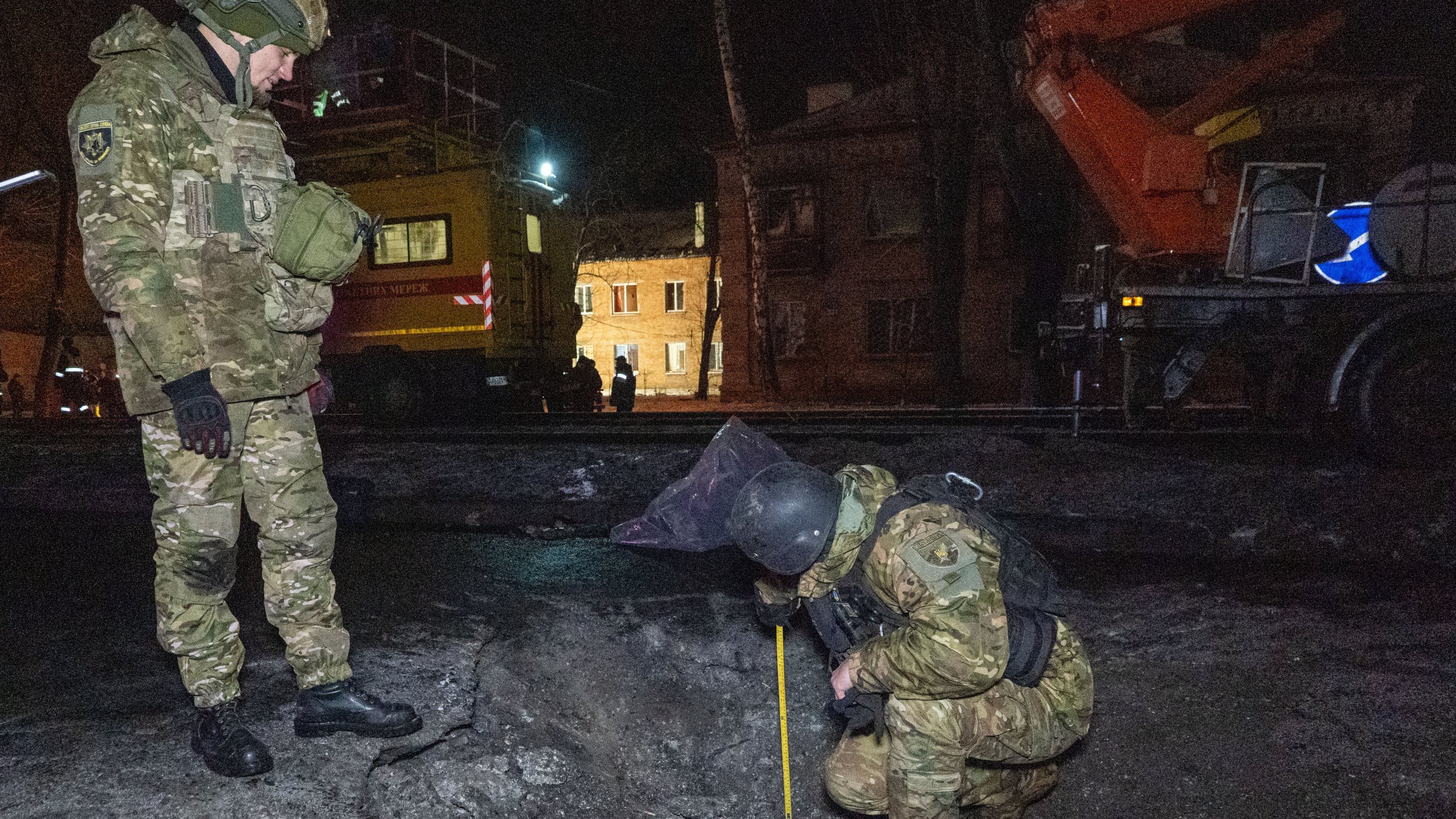 Police officers inspect inspect the site of the Russian airstrike in Kharkiv, Ukraine, Friday, Dec. 26, 2025. (AP Photo/Andrii Marienko)