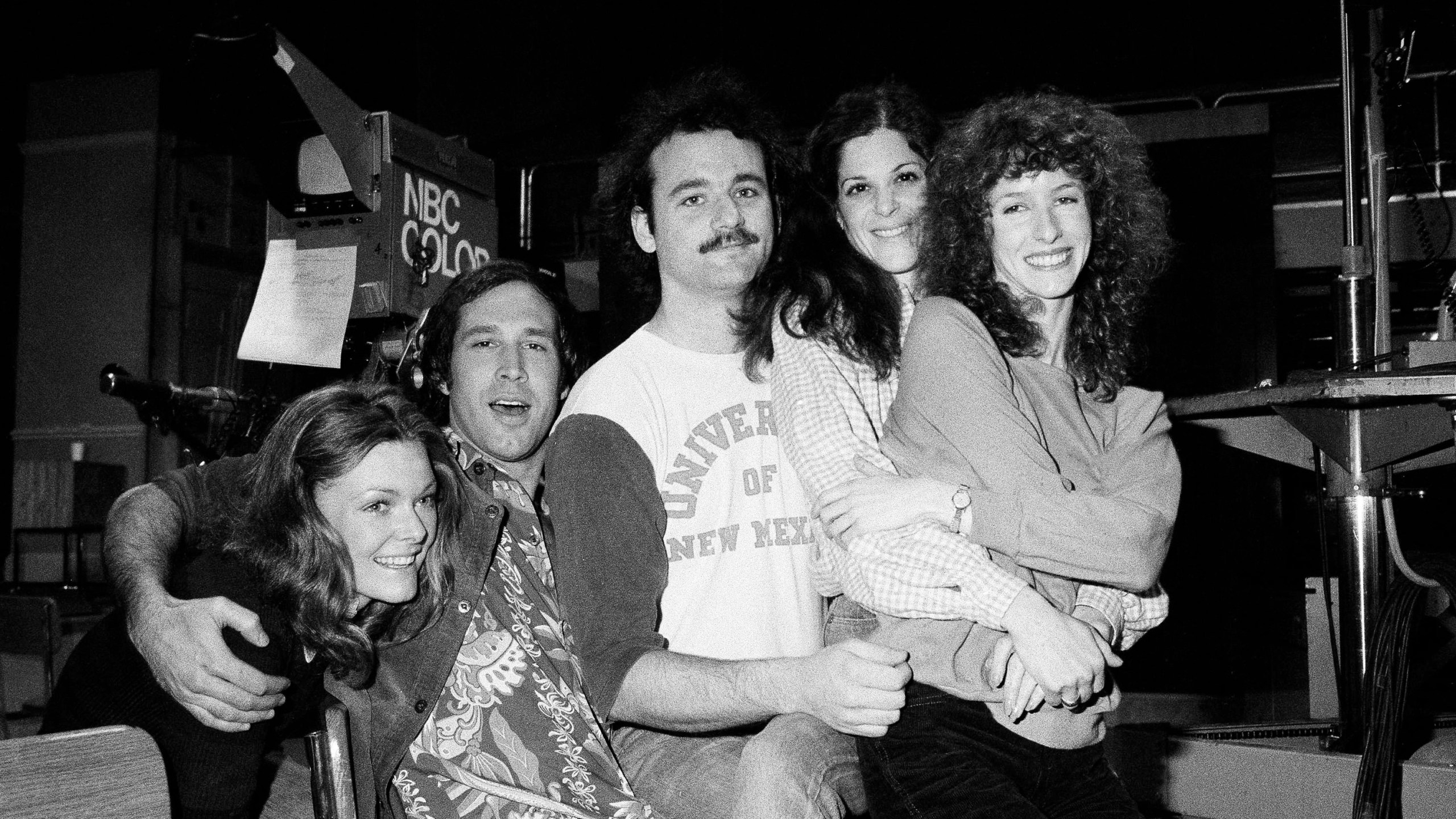FILE - Comedian Chevy Chase, second from left, joins cast of NBC-TV's "Saturday Night Live," Feb. 16, 1978 in New York, where he first got his start with the "Not Ready For Prime Time Players." Others are, from left, Jane Curtin, Bill Murray, Gilda Radner, and Laraine Newman. Chase is doing a guest shot on the program. (AP Photo/Marty Lederhandler, File)