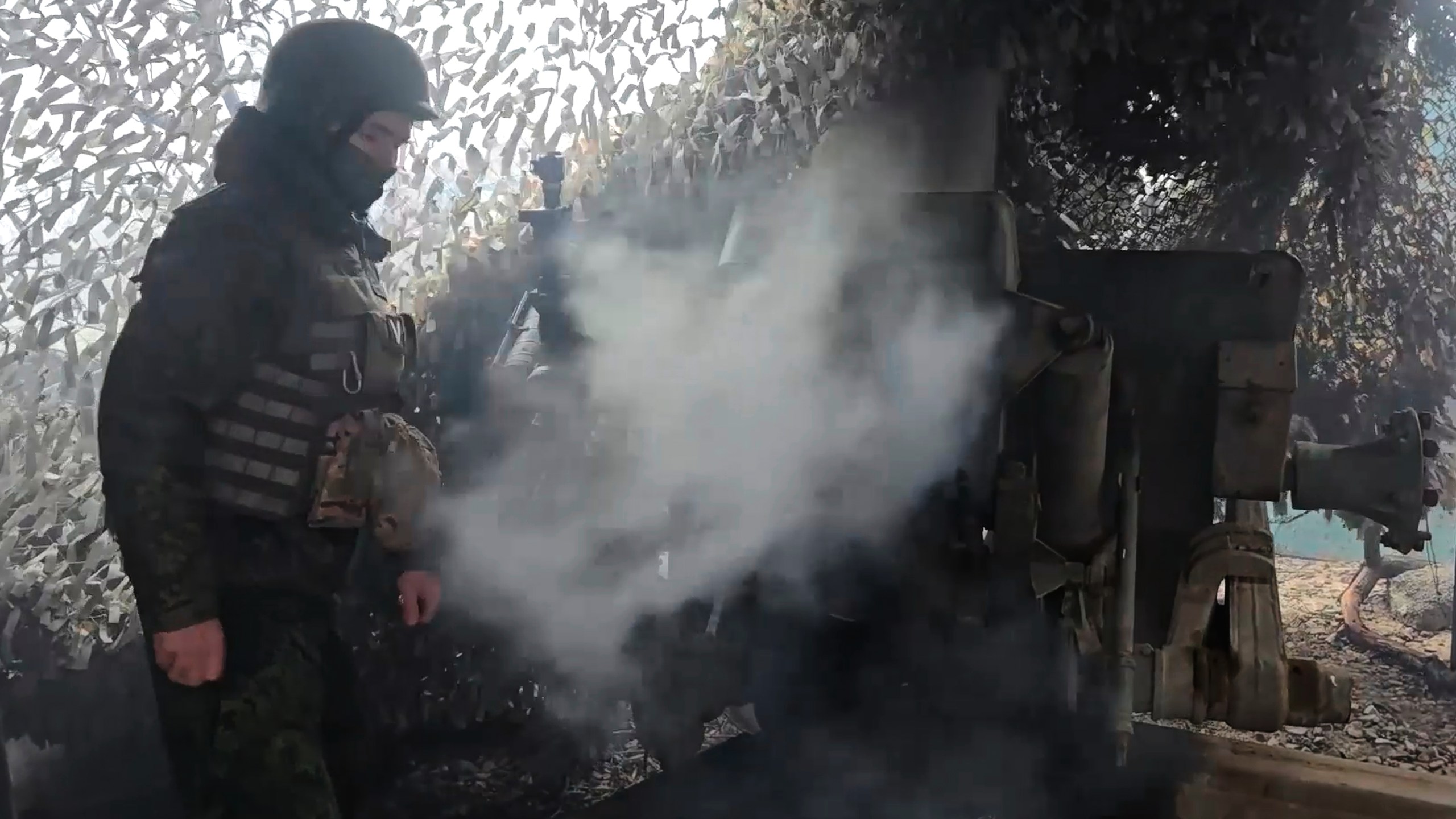 In this image made from video provided by the Russian Defense Ministry Press Service on Tuesday, Dec. 30, 2025, a Russian Army soldier fires from D-30 howitzer towards Ukrainian positions in an undisclosed location in Ukraine. (Russian Defense Ministry Press Service via AP)