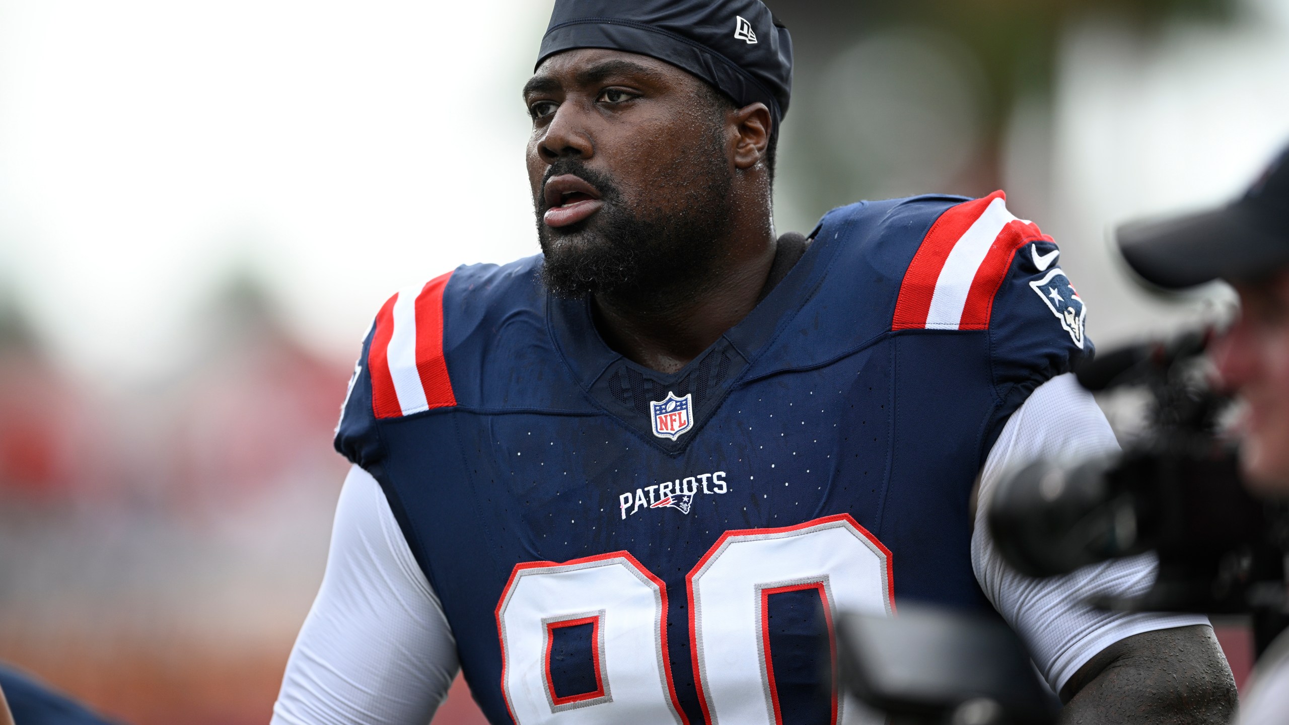 FILE - New England Patriots defensive tackle Christian Barmore (90) warms up before an NFL football game against the Tampa Bay Buccaneers, Sunday, Nov. 9, 2025, in Tampa, Fla. (AP Photo/Phelan M. Ebenhack, File)