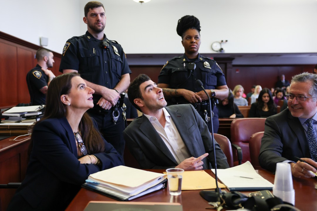 Luigi Mangione appears in court alongside his attorneys and two police officers