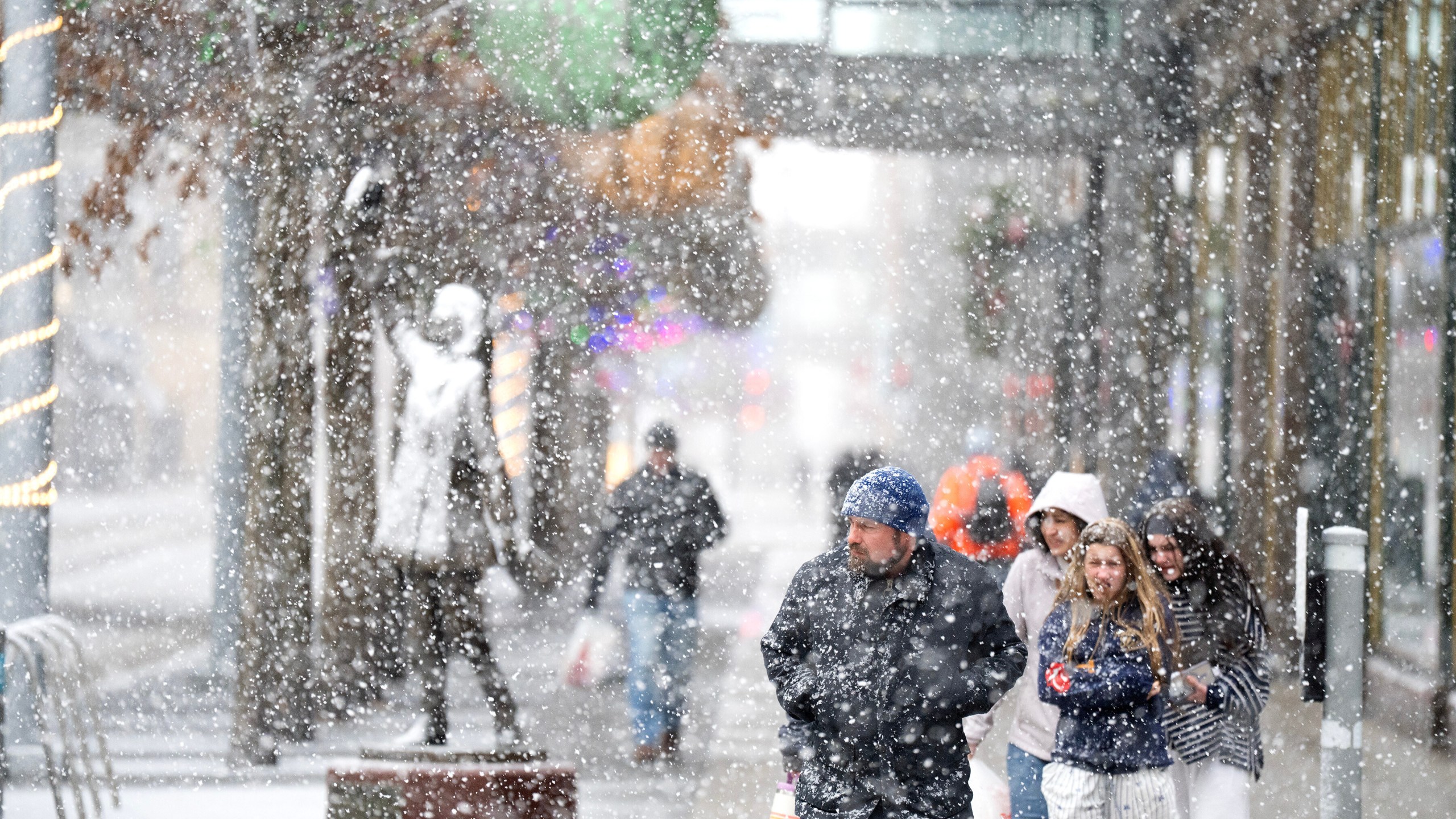People walking amid heavy snow fall in Minneapolis